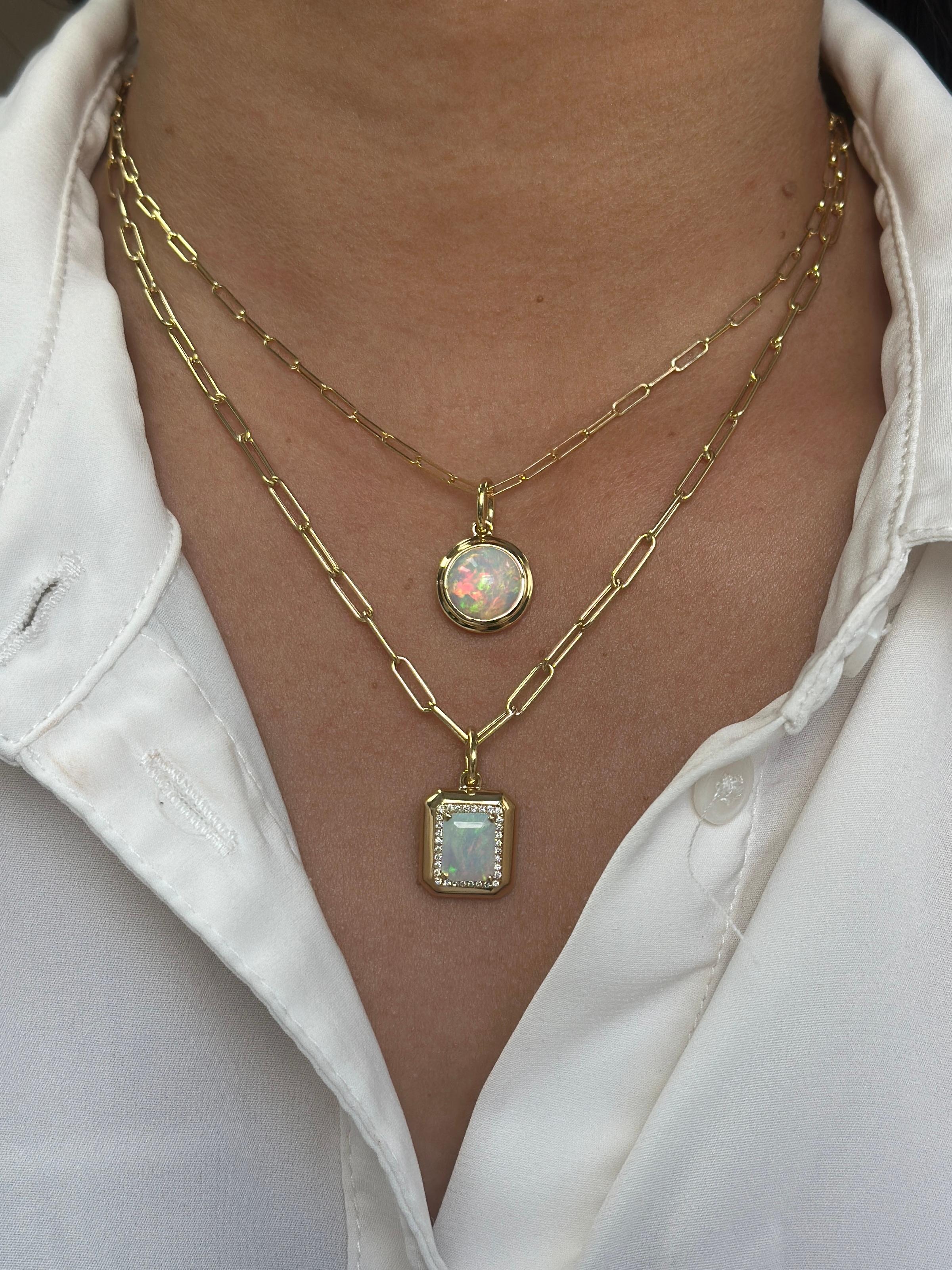 Radiate elegance with this Emerald-Cut Opal Pendant, beautifully set in 18K Yellow Gold and accented with shimmering diamonds. The 9x7 mm Opal displays a mesmerizing play of colors, complemented by 0.13 cts of sparkling diamonds.

Details:
Opal