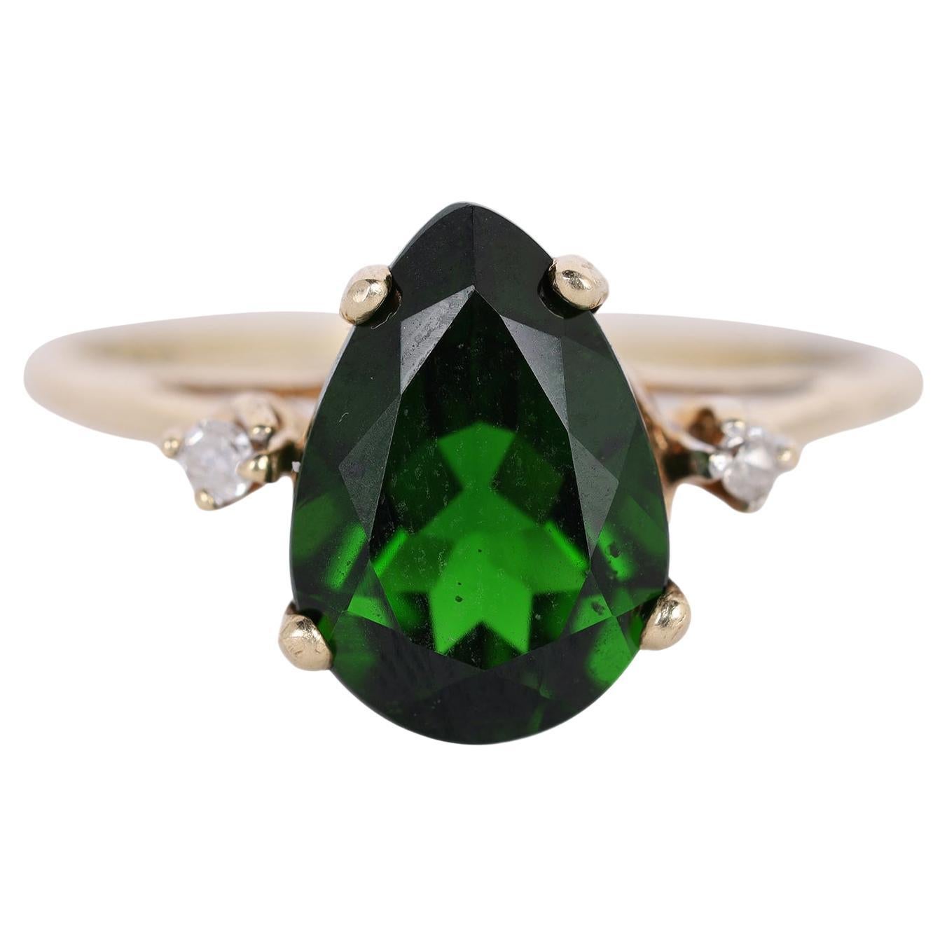 Curated by The Lady Bag Ladies 

Being offered for sale is a 10Kt Yellow Gold Dark Green Emerald & Diamond Ring.

The ring features a pear cut and yellow gold prong set dark green lab created emerald as the main stone. It measures 10.12mm in height