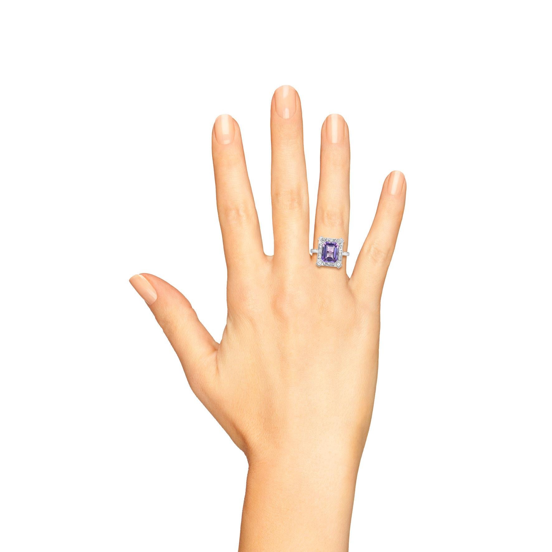 This beautiful Art Deco style amethyst ring is centered with an emerald cut pink amethyst. Glittering and white in both baguettes and round brilliant diamonds, the white gold setting provides a lifetime of elegant utility. Adorn yourself with this