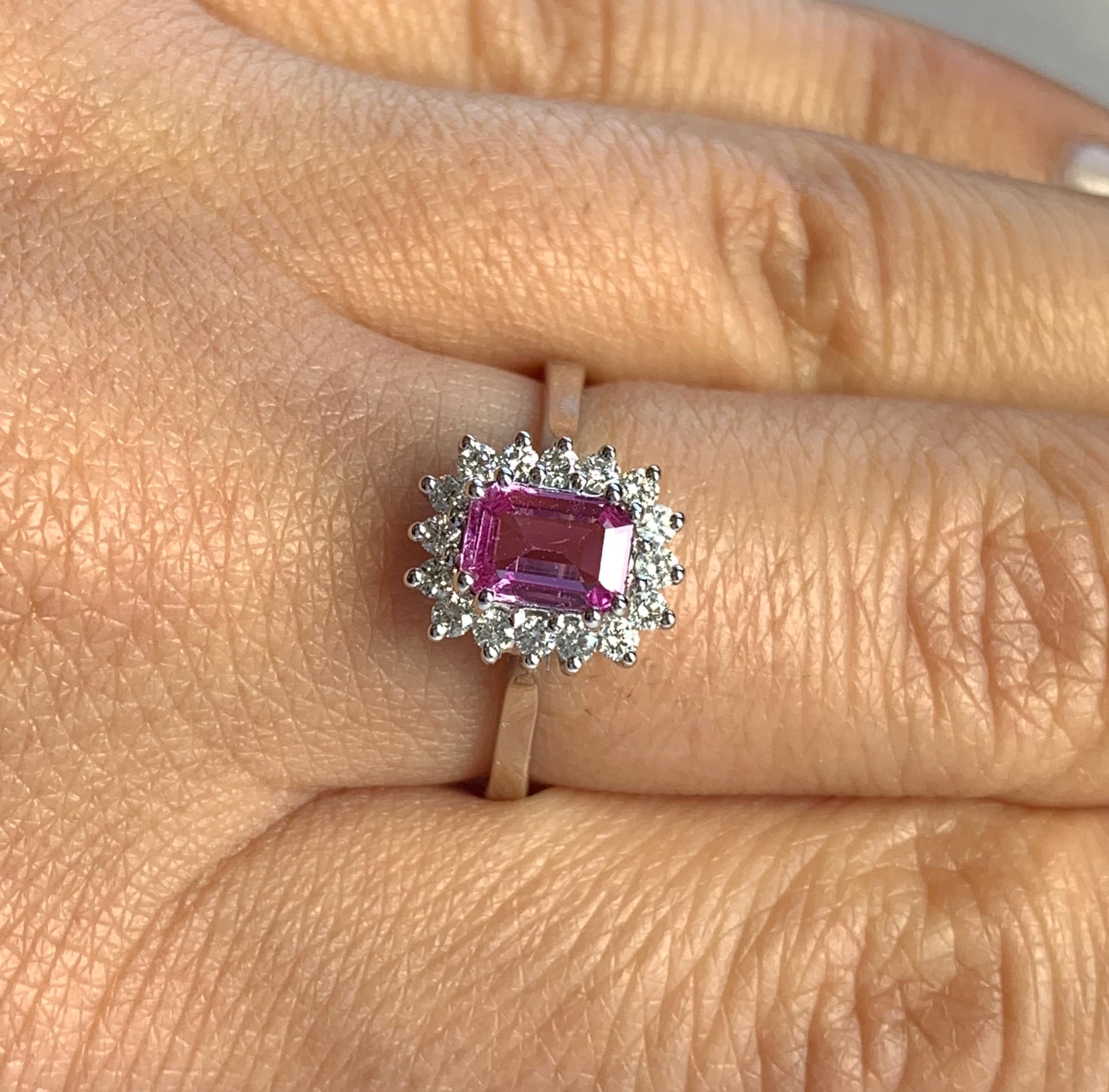 Material: 14k White Gold 
Center Stone Details: 0.63 Carat Emerald Cut Pink Sapphire 6 x 4 mm
Mounting Diamond Details: 16 Round White Diamonds Approximately 0.23 Carats - Clarity: SI / Color: H-I
Ring Size: Size 5.5. Alberto offers complimentary