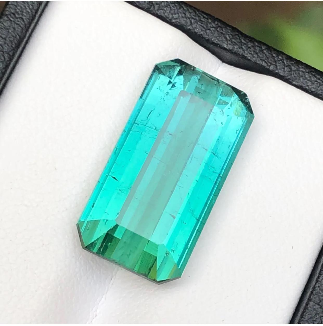 Behold the allure of our remarkable Neon Bluish Green Natural Loose Gemstone, a substantial 14.75 Carats of pure elegance sourced from the prestigious Jaba Mine in Kunar, Afghanistan. This breathtaking gem is a testament to nature’s artistry,