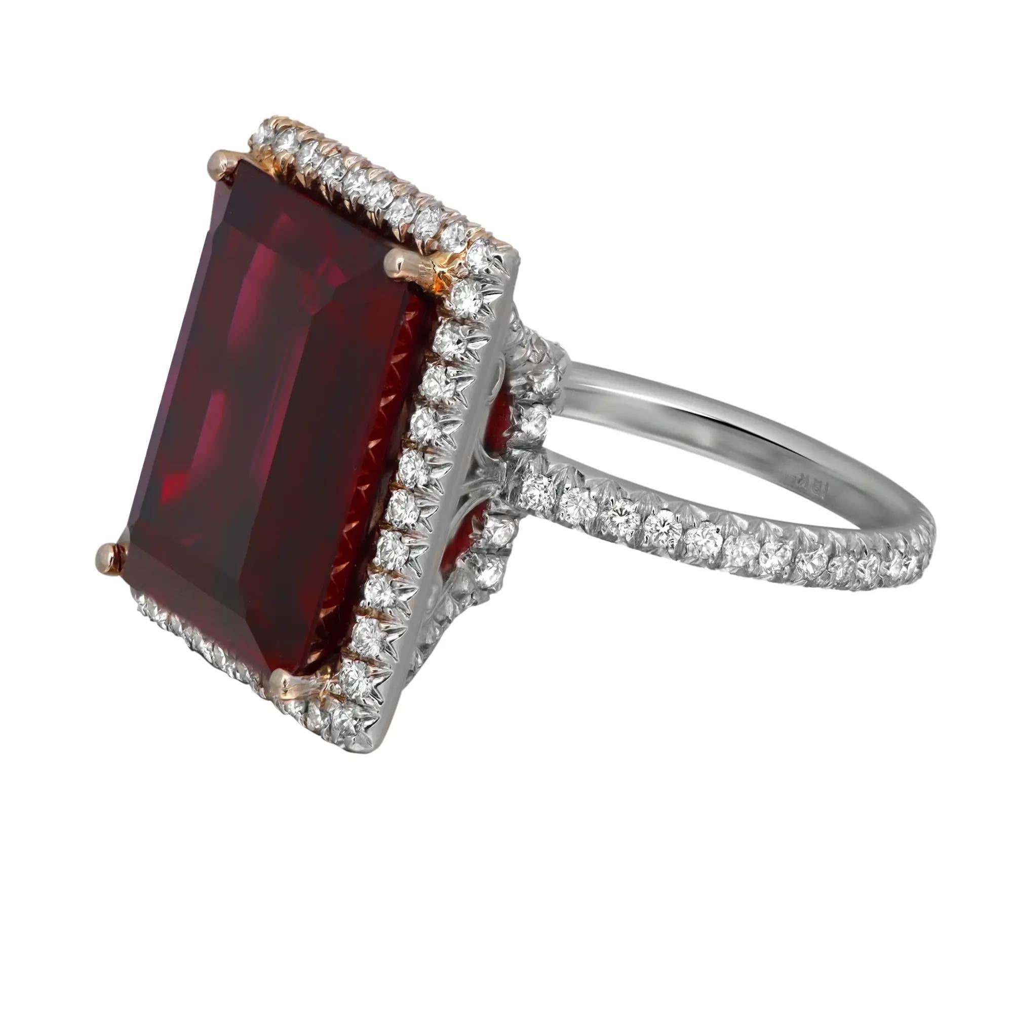 Wrap your finger with this stunning ring showcasing a prong set emerald cut Rhodolite weighing 16 carats surrounded by a halo of tiny round brilliant cut diamonds with diamonds on the metal basket and all around the band. Crafted in 18K white gold.