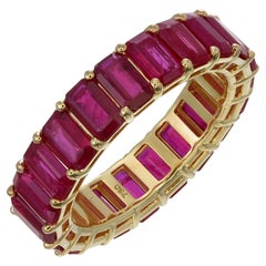 Emerald cut ruby eternity band in 18kt