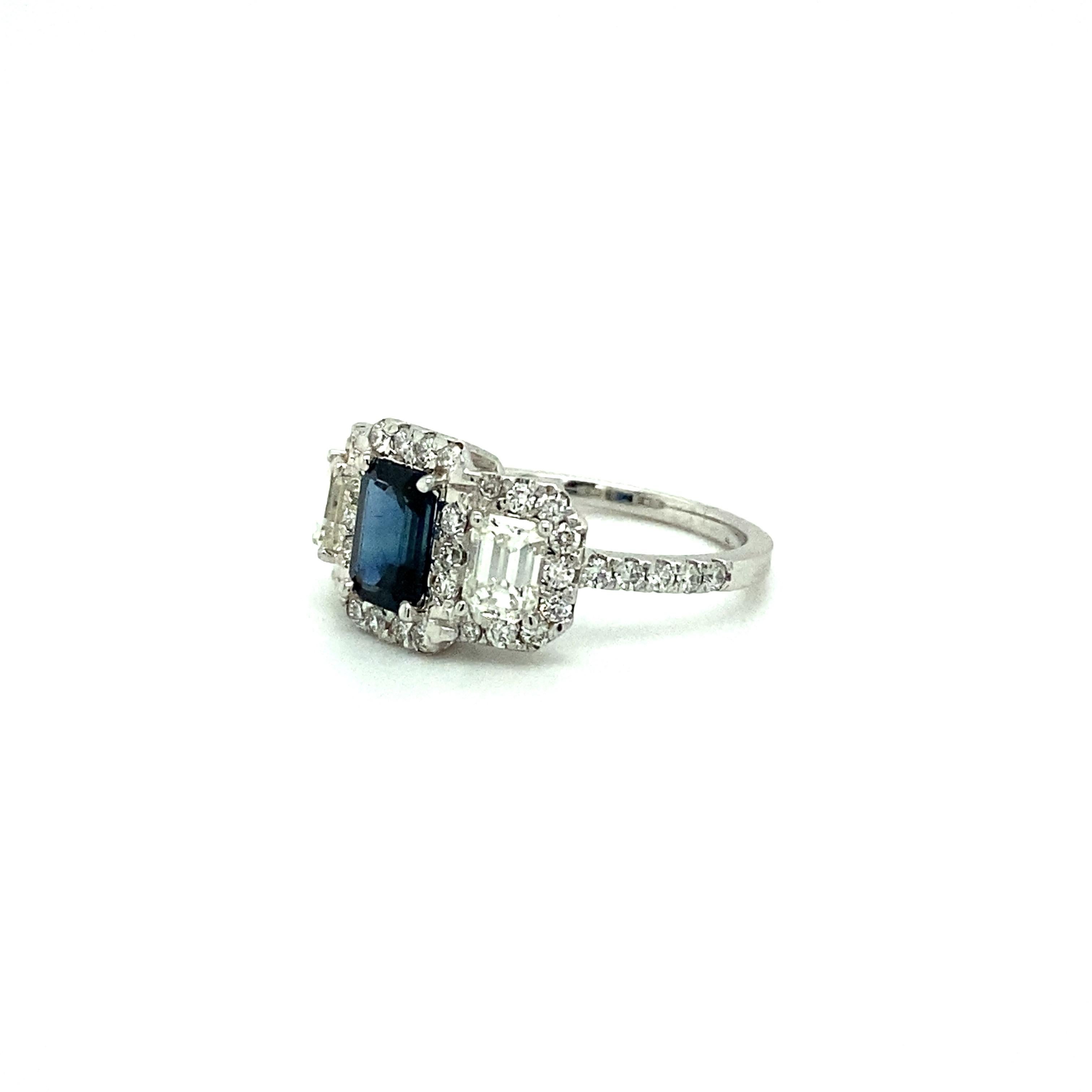 Offered here is an Emerald Cut Sapphire and Diamond Ring created and hallmarked by us, hallmarked Kozi 18k.
Designed and handmade in our boutique atelier in Miami, Florida.
Featuring 1 natural earth mind blue emerald cut sapphire, weighing 0.85
