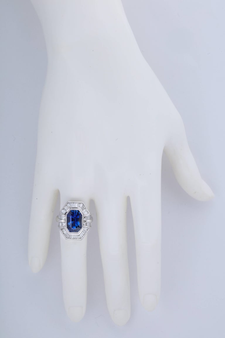 A bright, vibrant blue is what you want in a sapphire and this ring has all of that and more.  The long emerald cut shape is wonderfully elegant and it works perfectly with all of the baguette diamonds set in the mounting.  The ring was was made in