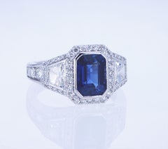 Emerald Cut Sapphire Ring with Trapezoid Diamonds