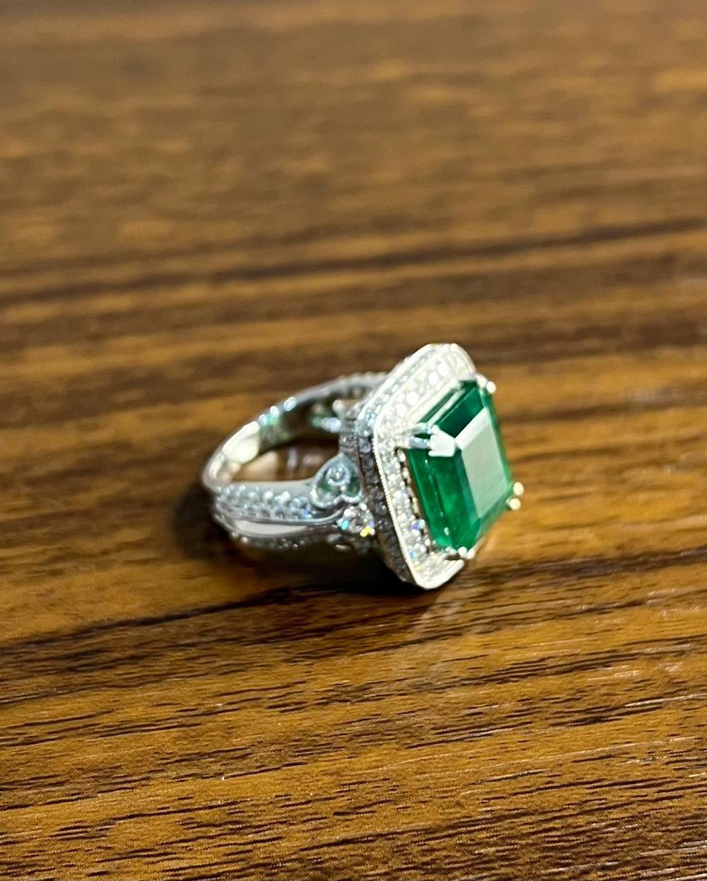 A striking Emerald and Diamond Ring, featuring a captivating emerald-cut emerald set in a halo of sparkling diamonds, mounted on a sleek white gold band.
18 Solid White Gold 
Diamonds 1.35 CTW
Emerald Cut: 8.01 CTW