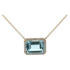 Emerald Cut Sky Blue Topaz with Diamond Halo 10.16 CTTW 14 Karat Yellow Gold