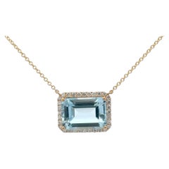 Emerald Cut Sky Blue Topaz with Diamond Halo 10.16 CTTW 14 Karat Yellow Gold