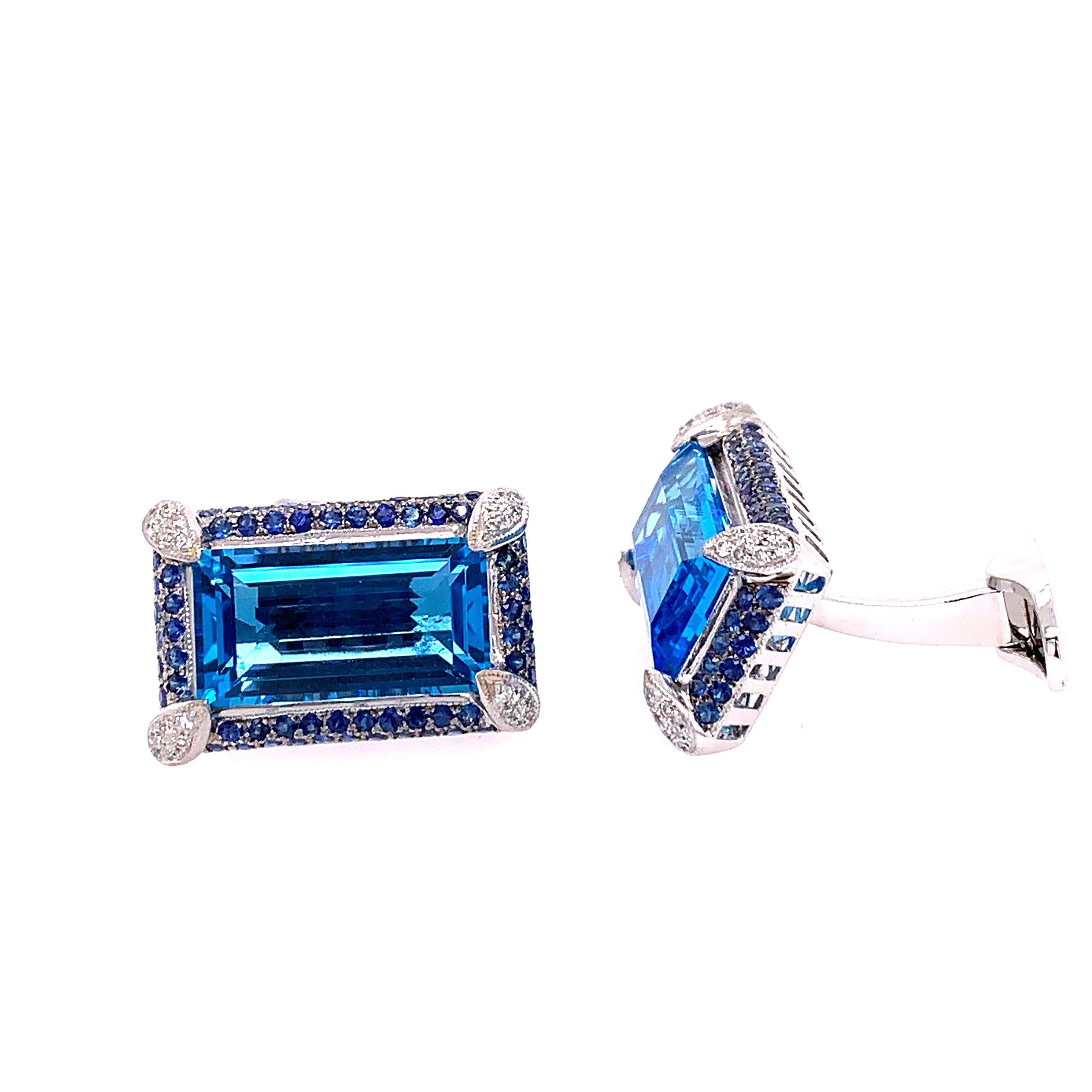 These one of a kind beautiful Emerald Cut Blue Topaz cuff links feature 2 Topaz Stones weighing approximately 16 carats.
These stones are framed with approximately 1.30 carats of Blue Sapphires as well as approximately .25 carats of white
