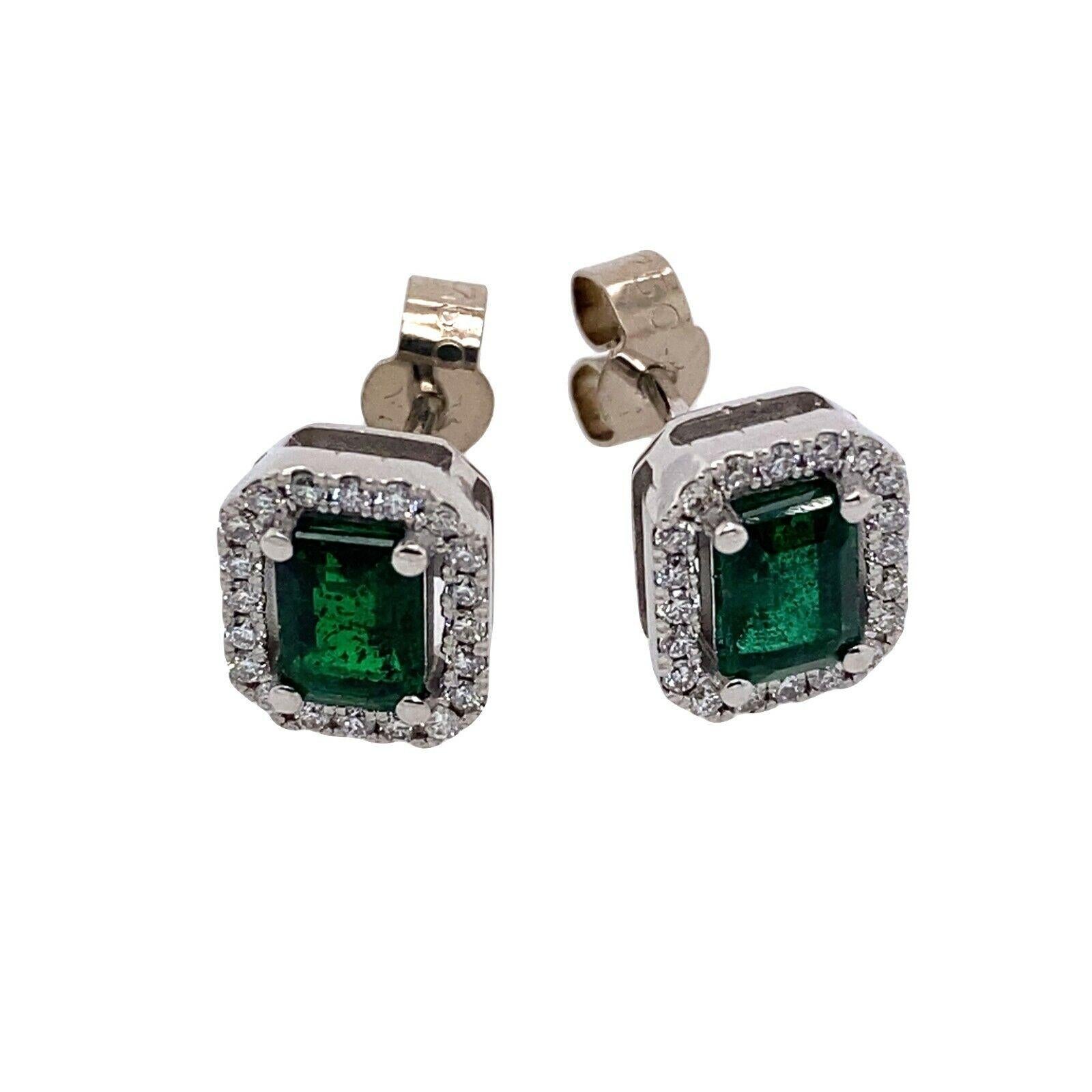 New Emerald Cut Zambian Emeralds, Surrounded by Diamonds, Set In 18ct White GoldWith 0.35ct of Diamondsand 1.45ct of emeraldsWith Peg & Screw FittingsMade by Jewellery Cave.

Additional Information:
Total Diamond Weight: 0.35ct 
Diamond Colour: