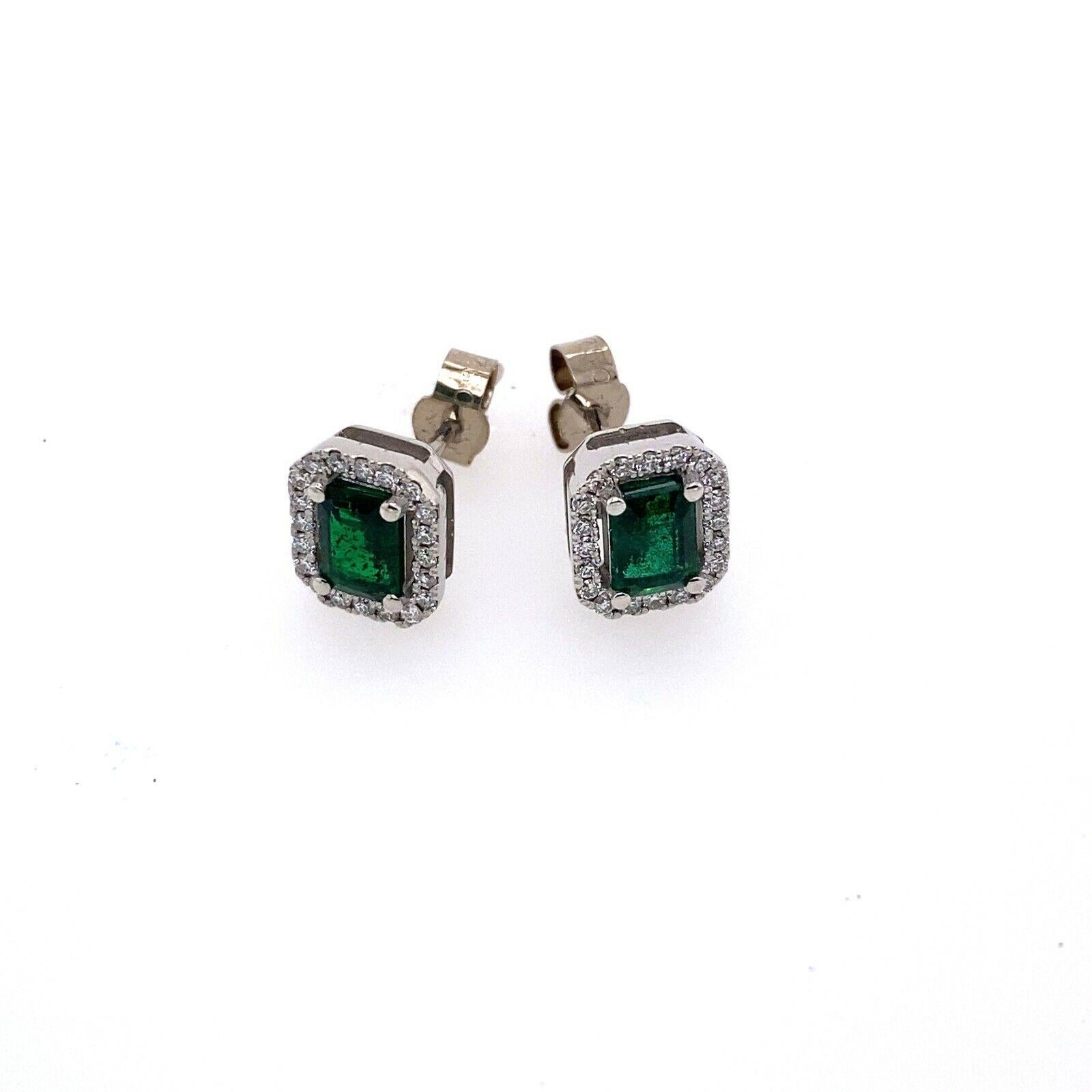 Women's Emerald Cut Zambian Emeralds Surrounded by Diamonds Set in 18ct White Gold For Sale