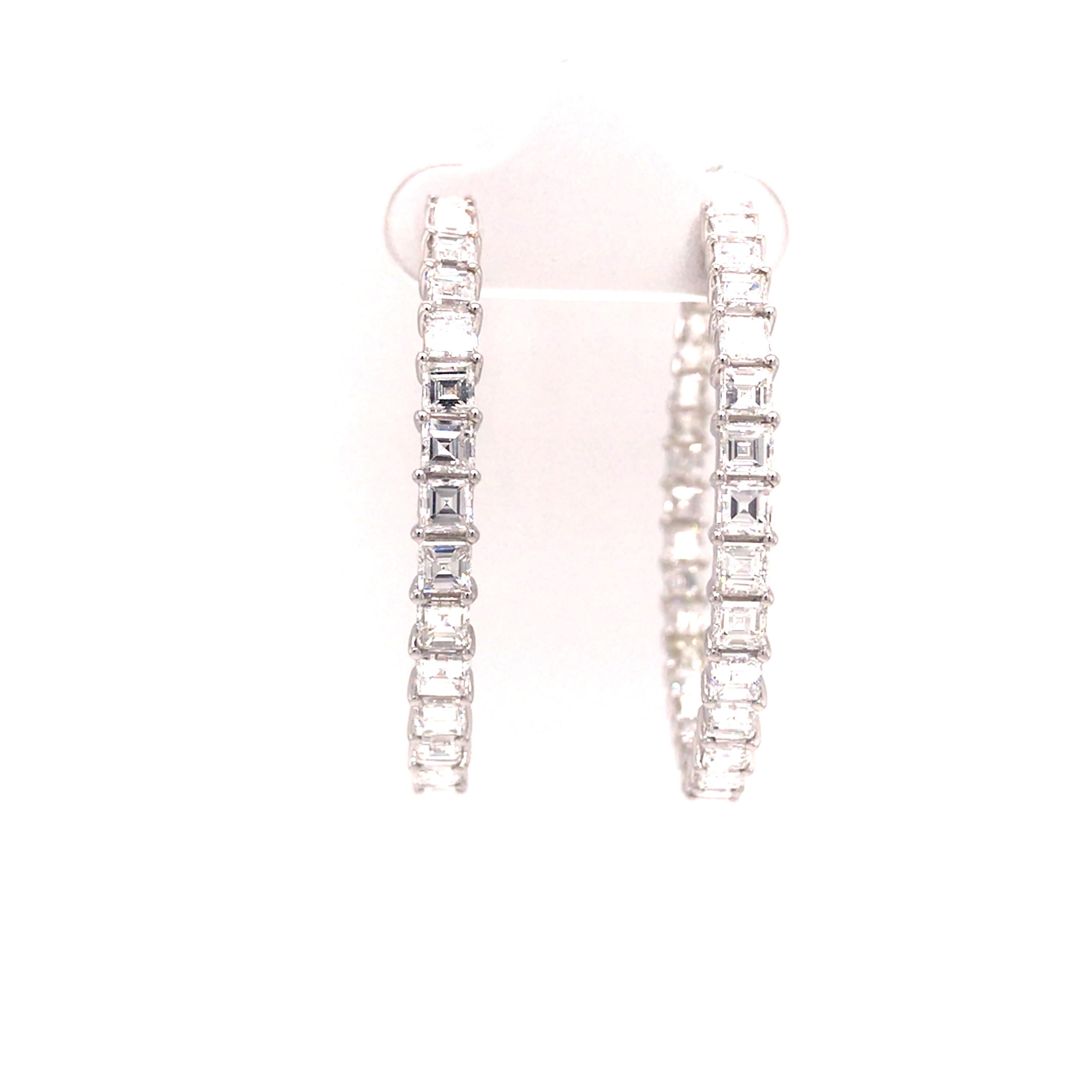 Emerald Diamond 1 1/2 inch In/Out Hoop Earrings in 18K White Gold.  (58) Emerald Cut Diamonds weighing 6.80 carat total weight, G-H in color and VS-SI in clarity are expertly set.  The Earrings measure 1 1/2 inch in length and 1/8 inch in width.
