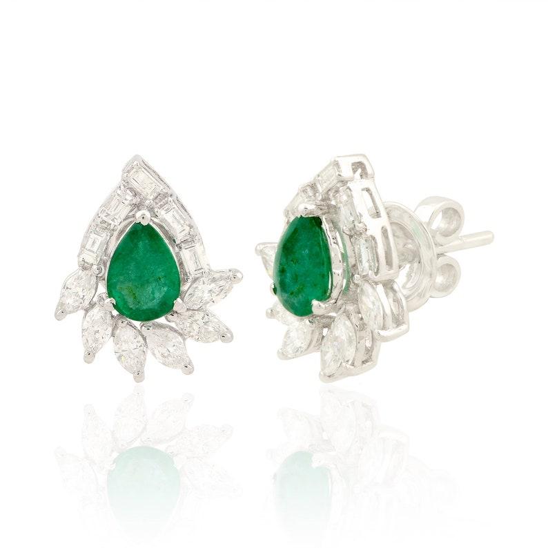 Cast in 14 karat gold, these stud earrings are hand set with 1.03 carats emerald and 1.0 carats of glimmering diamonds. 

FOLLOW MEGHNA JEWELS storefront to view the latest collection & exclusive pieces. Meghna Jewels is proudly rated as a Top