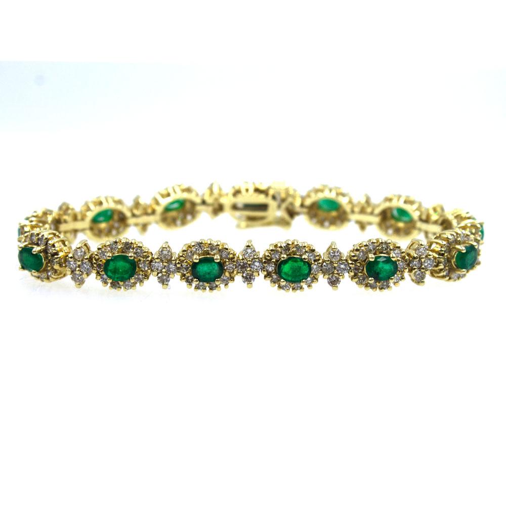 This exquisite station bracelet features an array of diamonds and emeralds. The 13 oval cut emeralds (3.90 carat total weight) are surrounded by 182 round brilliant cut diamonds (4.00 carat total weight of diamonds). The bracelet is designed in 14