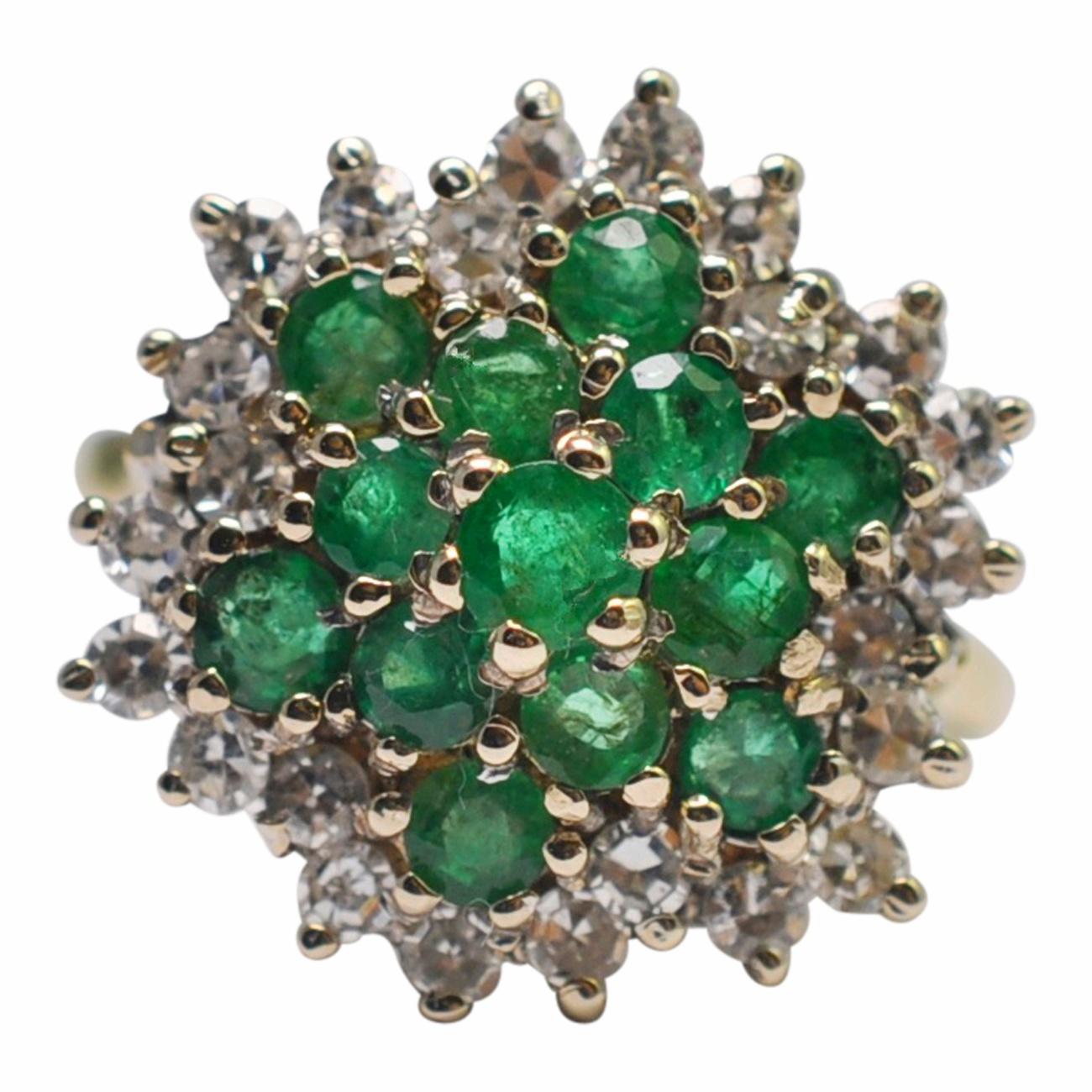 Emerald and diamond snowflake cluster ring in 18ct gold;  this is a gorgeous statement ring, unusually set with emeralds as these rings are more traditionally set with sapphires or rubies.  The stones are mounted up on wirework basket, and the ring