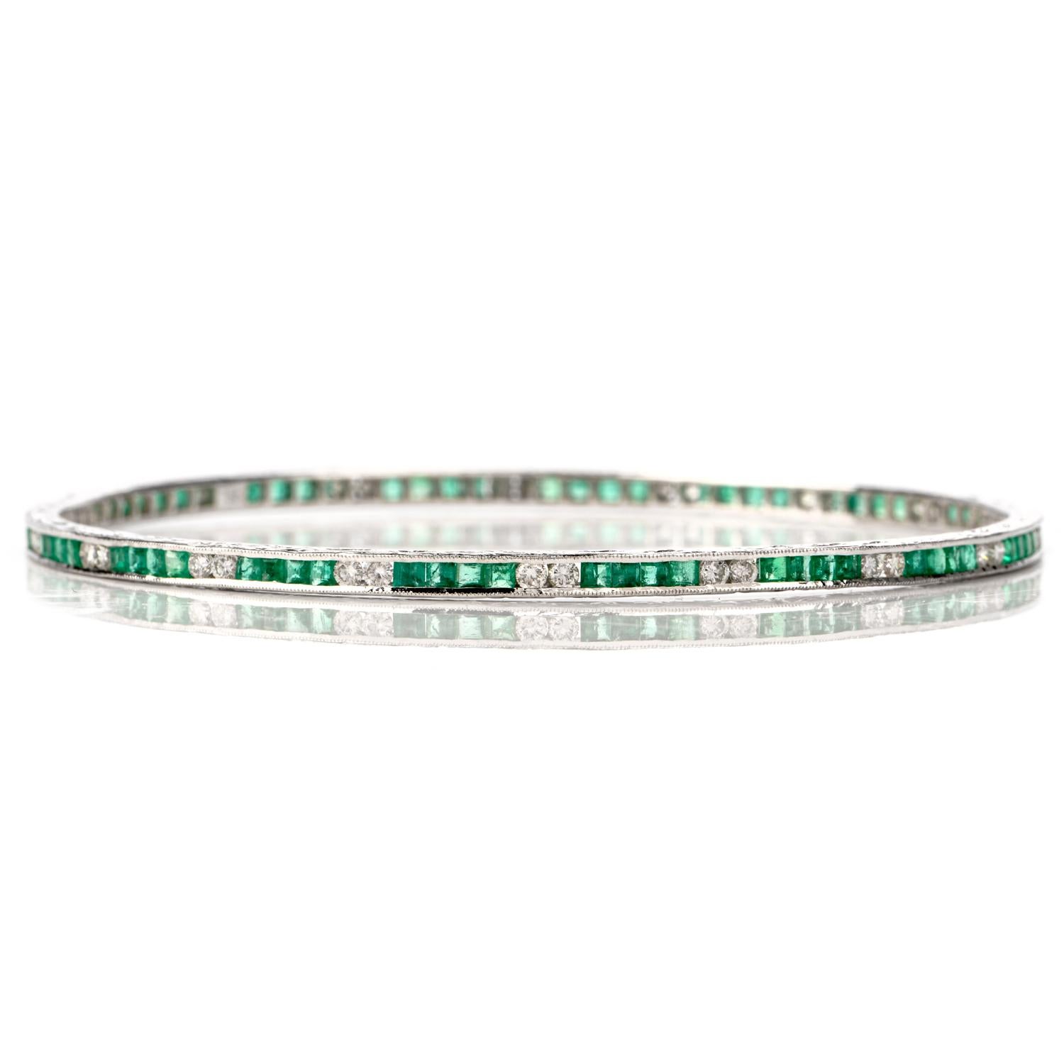 This stunning emerald and diamond bangle bracelet is crafted in 18-karat white gold. Composed of a pattern of four channel-set emerald-cut emeralds and two channel-set round brilliant diamonds. The 72 genuine emeralds collectively weigh