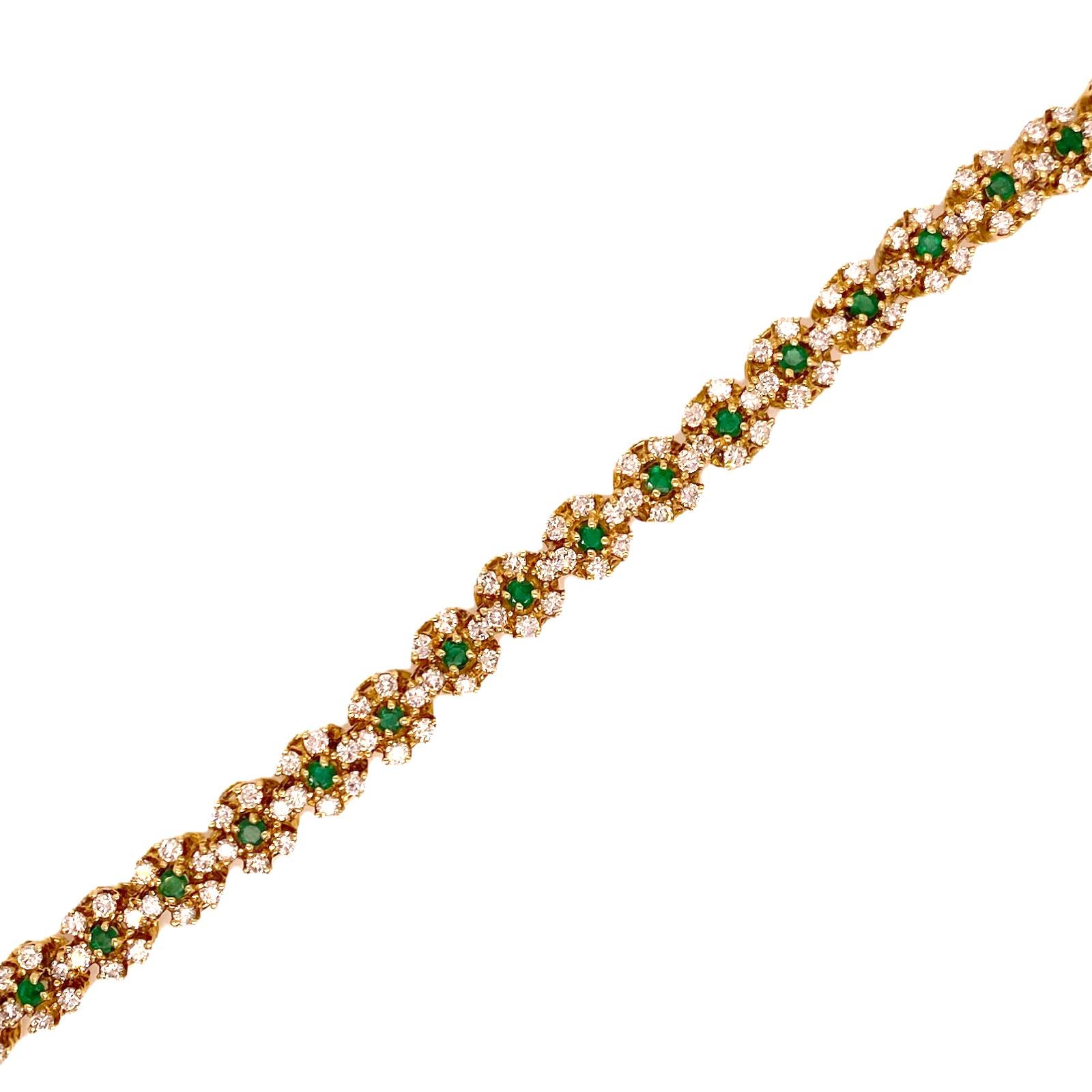 Gorgeous emerald and diamond bracelet fashioned in 18 karat yellow gold. The 23 green emeralds weigh 1.50 carat total weight and are surrounded by 135 round brilliant cut diamonds weighing 5.00 carat total weight. The diamonds are graded F-G color
