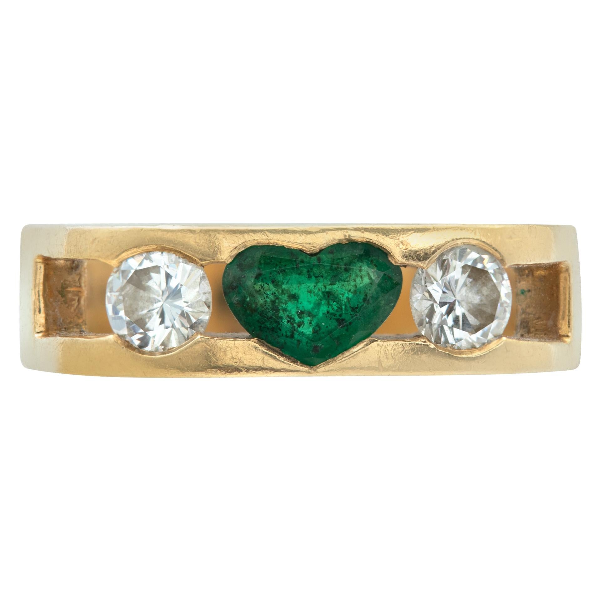 Heart shape emerald & round diamond ring with an aprroixmate 0.50 carat emerald and two approximate 0.20 carat side diamonds set in 18k yellow gold. Size 5.5.

This Diamond/Emerald ring is currently size 5.5 and some items can be sized up or down,