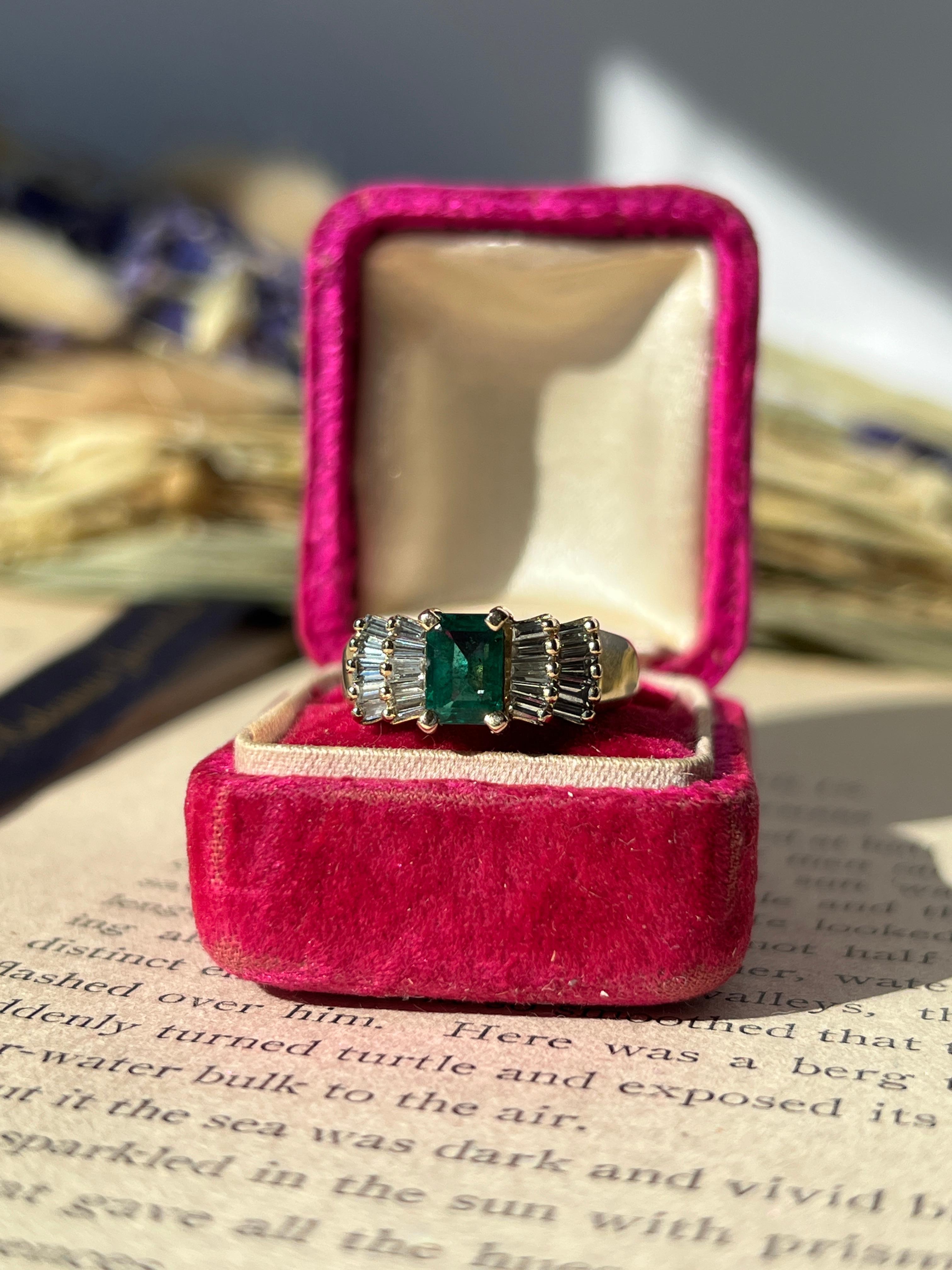 One 1970s emerald and diamond ring showcasing a vibrant 0.80-carat emerald-cut emerald, flanked by an architectural array of 20 tapered baguette diamonds. The diamonds, graded H/I color and VS1 clarity with a total carat weight of 0.50, create a