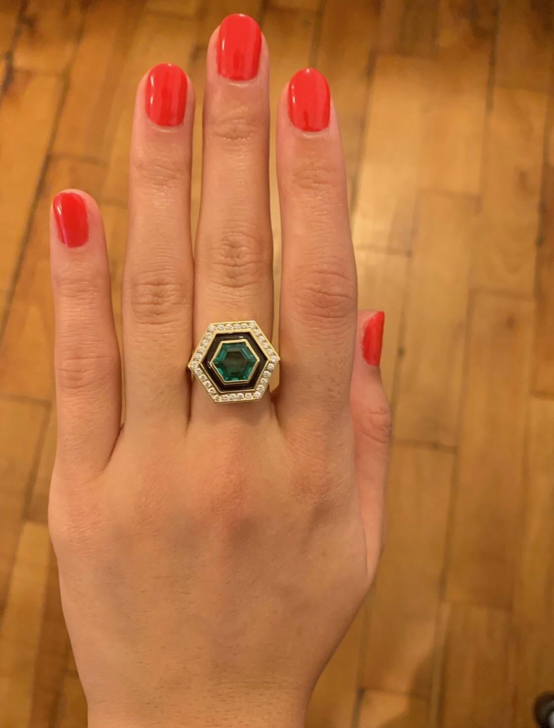 Beautiful 2.12 carat Hexagonally cut Emerald. A beautiful stone with a rich, strong emerald green color. It is surrounded by a black band of enamel and  .39 carats of GH color VSI diamonds. It is part of Andrew Glassford's Museum collection and is