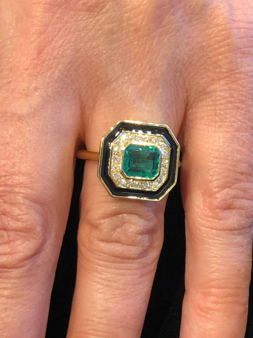 Beautiful 1.70 carat octagon cut Emerald. A beautiful stone with a rich, strong emerald green color. It is surrounded by .30 carats of G color VSI diamonds and a band of black enamel. It is part of Andrew Glassford's museum collection and is