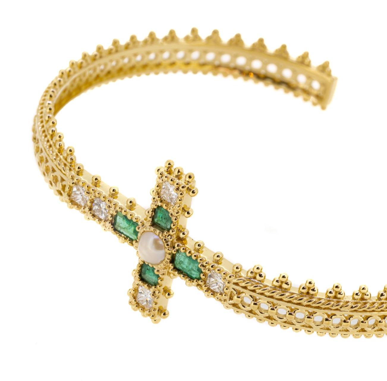 The Emerald Madonna Bracelet from Jade Jagger’s Madonna Collection is a beautifully bold and intricate piece. Crafted in 18K yellow gold, the bracelet’s central cross-shaped motif is set with four meticulously cut step-cut emeralds, totalling 0.47