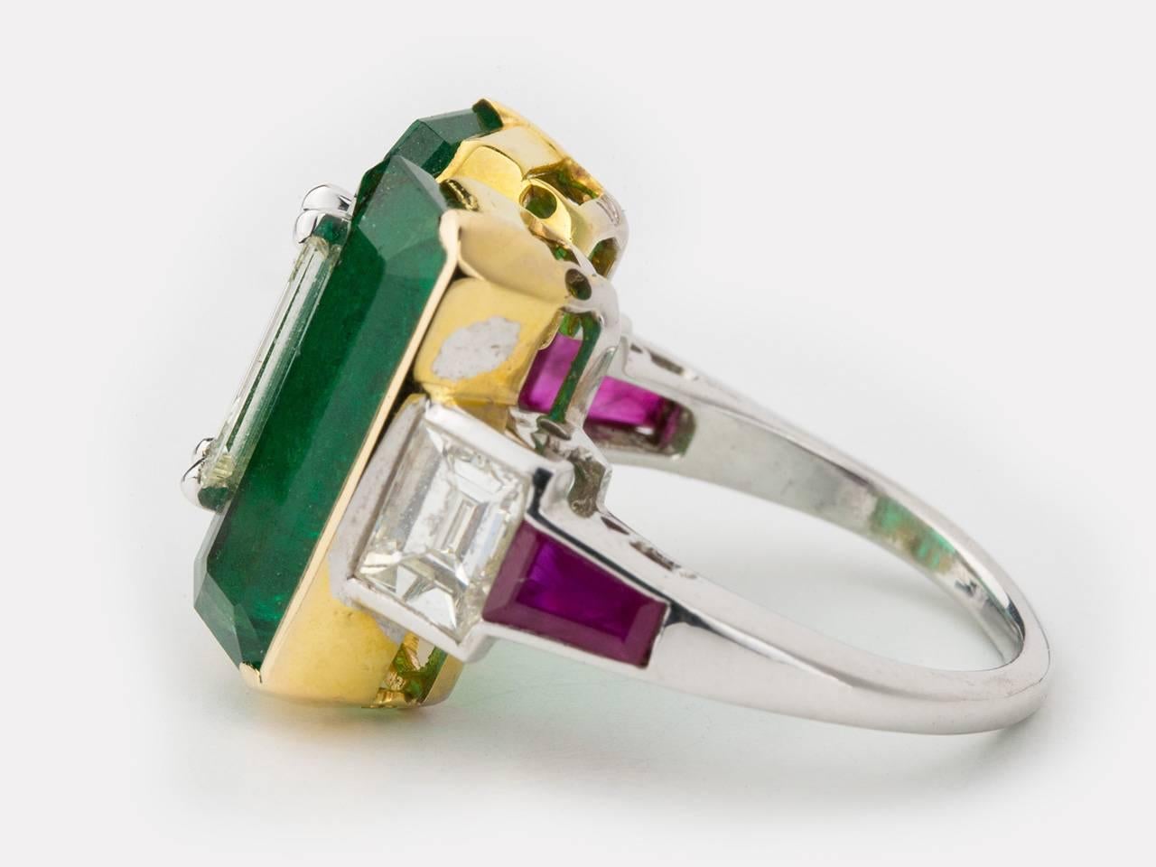 18k white and yellow gold ring set with 2 Zambian emeralds, flanked by baguette diamonds and shield-cut rubies.