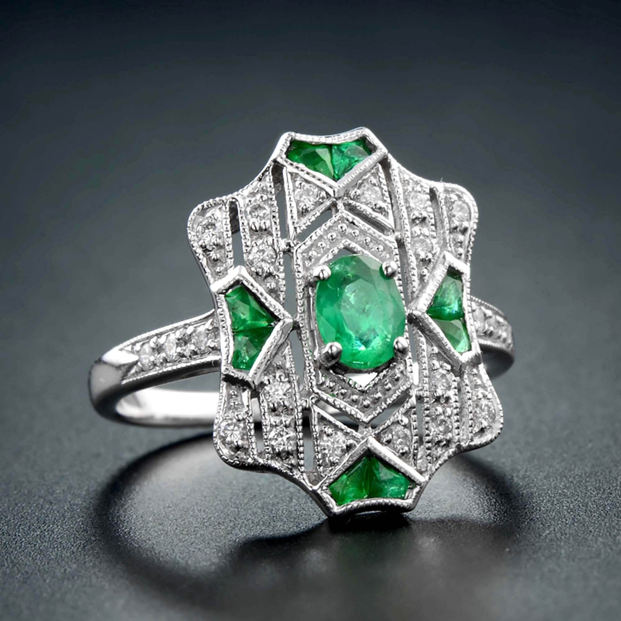 Uno smeraldo verde brillante e vibrante è il fiore all'occhiello di questo superbo e stupefacente gioiello fabbricato a mano, creato nel classico stile Art Deco. La splendida pietra preziosa è impreziosita da diamanti e smeraldi tagliati alla
