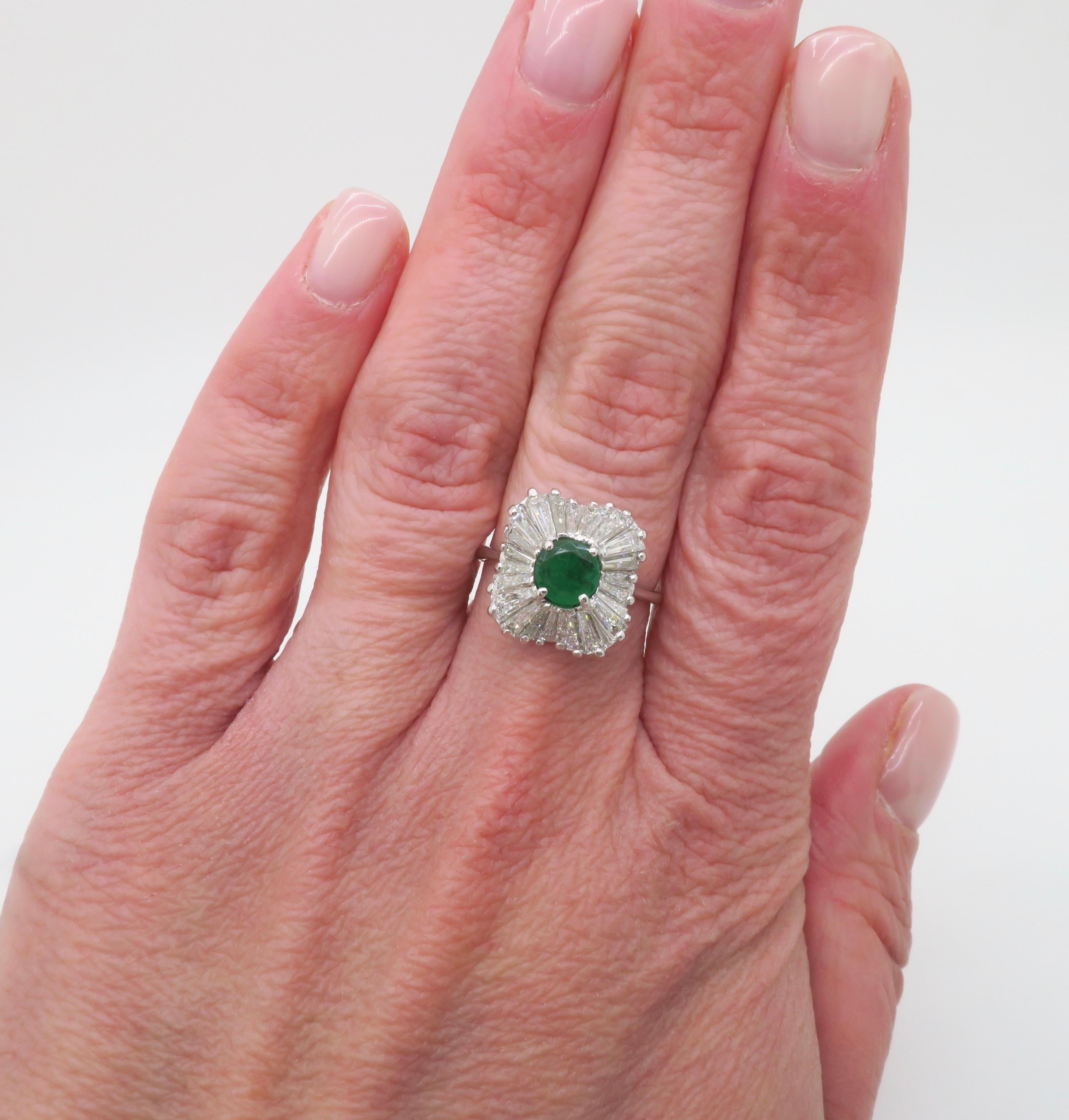 Natural Emerald and Diamond ballerina ring made in 14k white gold. 

Gemstone: Emerald & Diamond
Diamond Carat Weight: 2.10CTW
Diamond Cut: Baguette Diamonds
Diamond Color: E-F
Diamond Clarity: VS
Emerald Carat Weight: .50CTW
Metal: 14K White