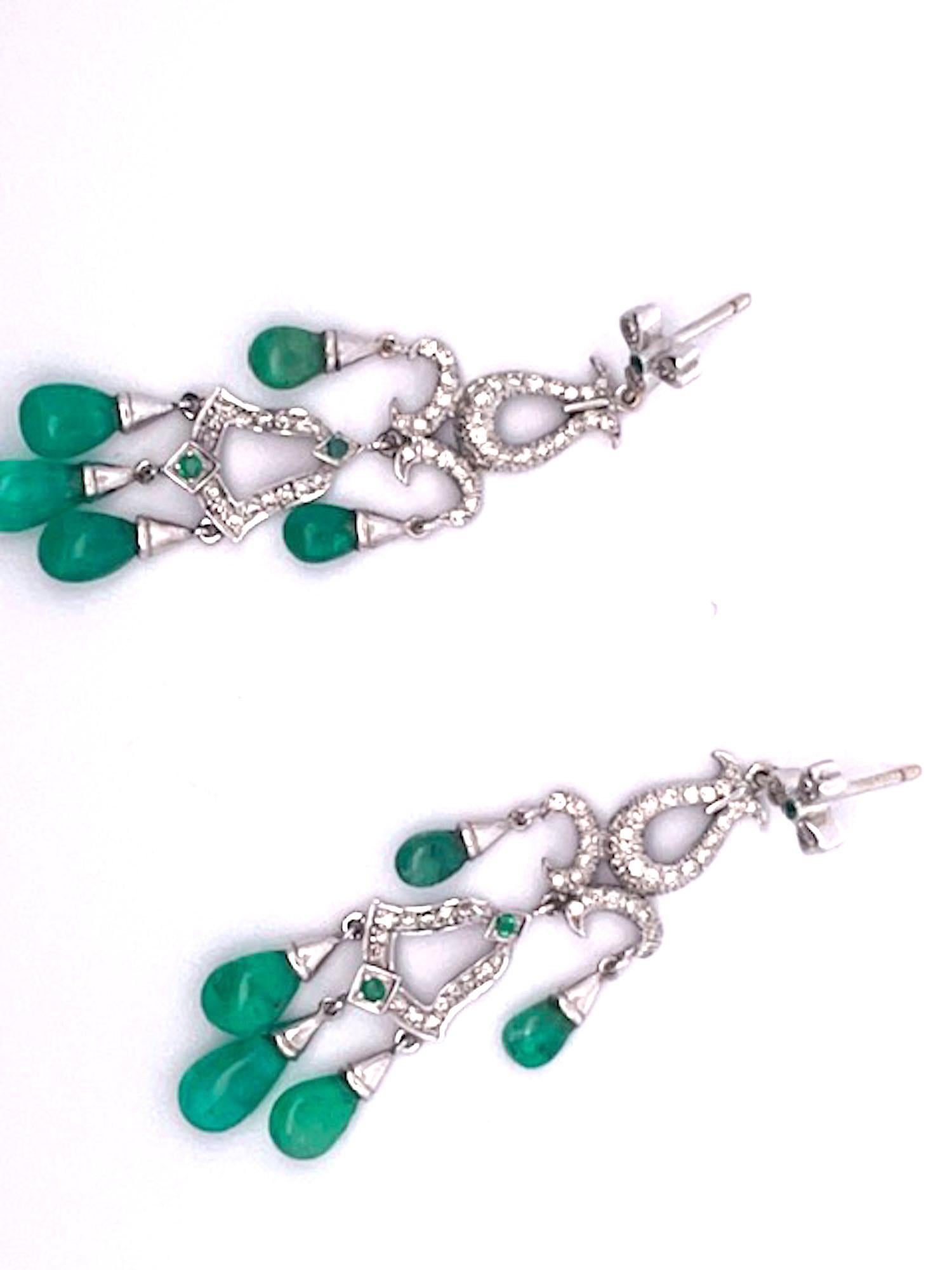 These gorgeous Chandelier Earrings are just beautiful.  They are made in 14K white Gold and set with five (5) Emerald Cabochon drops, three (3) small Emeralds are studded within the Diamonds. The length is 5.5 cm or 2 1/2