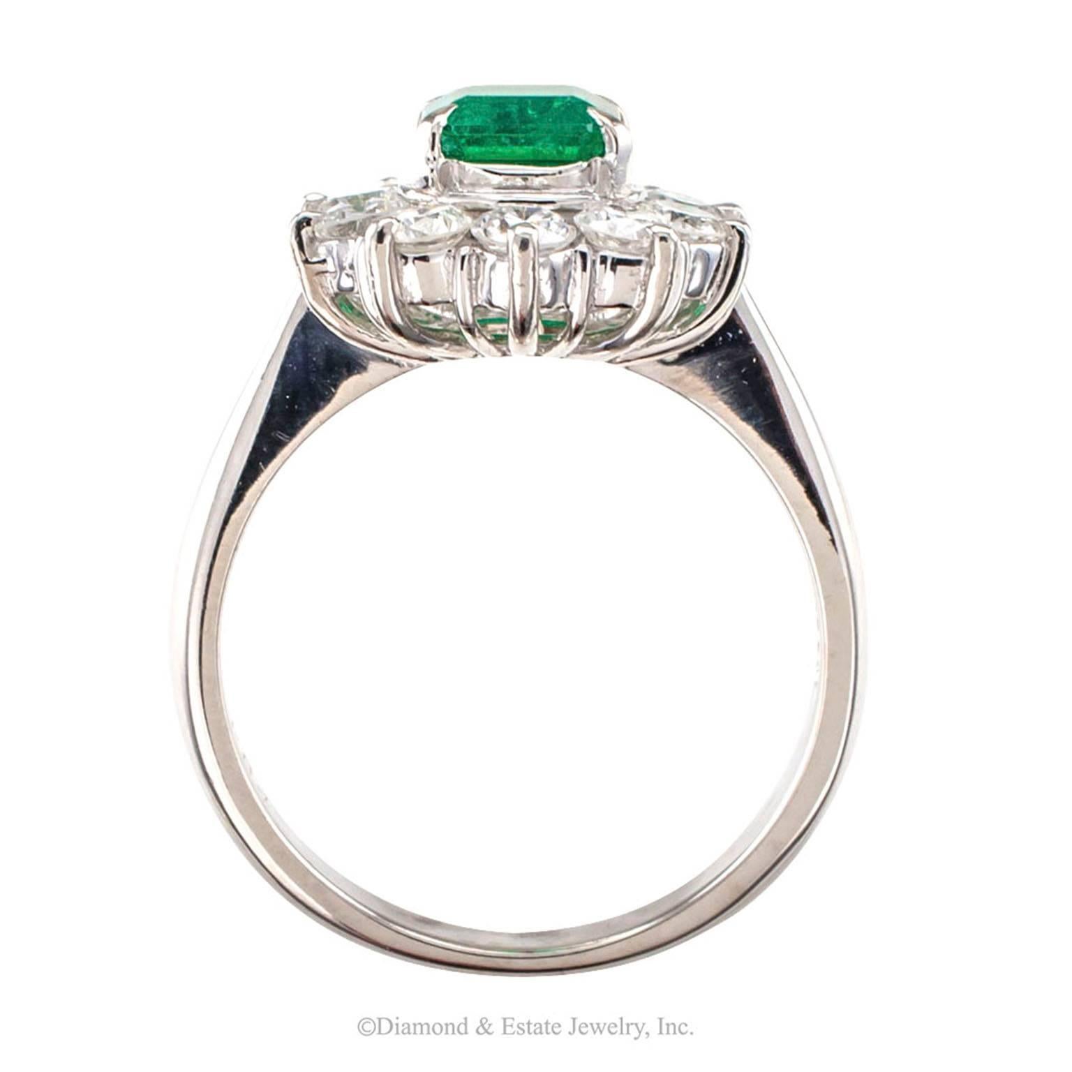 Emerald and diamond cluster ring circa 1990. *

ABOUT THIS ITEM:  #A7426. Scroll down for detailed specifications.  The Colombian emerald shows a beautiful deep green color and the diamonds have been matched for color and cut, set in a mounting that
