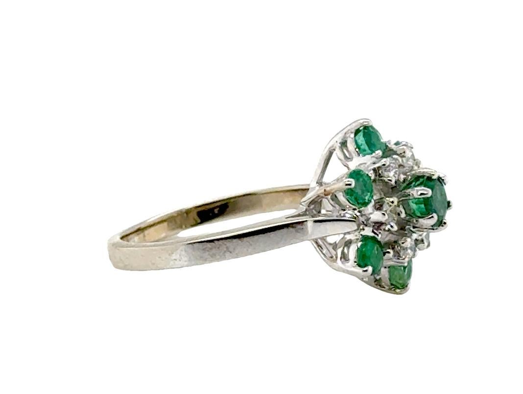 Emerald Diamond Cocktail Cluster Statement Ring 1ct 14K White Gold 
 
 
Features a Genuine Natural Mined .35ct Round Cut Emerald Gemstone Center

Emerald is the May Birthstone

Classic Cluster Style Cocktail Ring

Perfect for a Special Occasion or