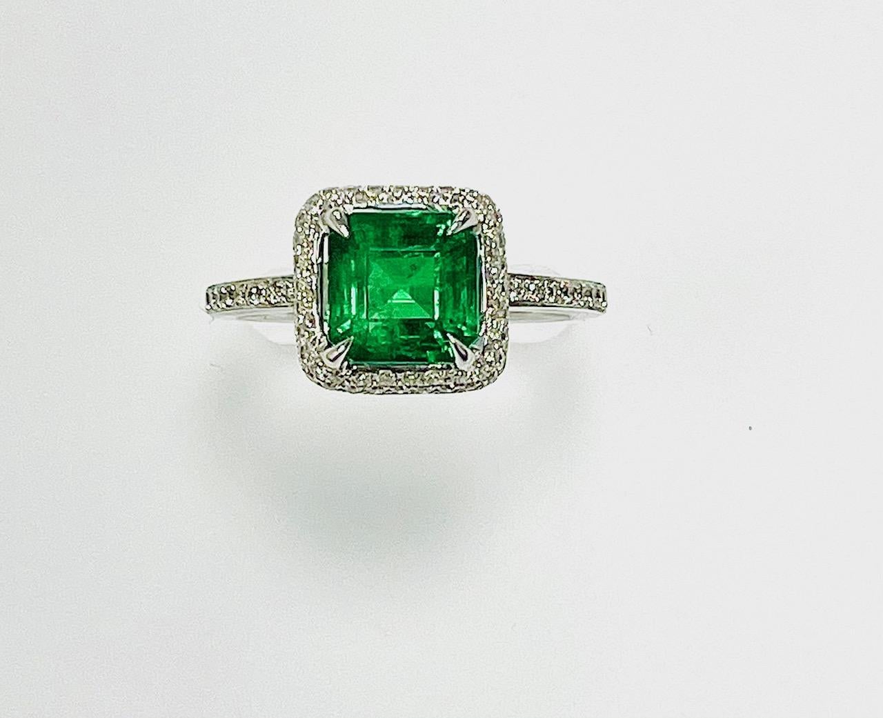 1.46 Carat Sqaure cut Zambian emerald set in 18k white gold ring with 0.38 carat diamonds around it and half way on the shank .