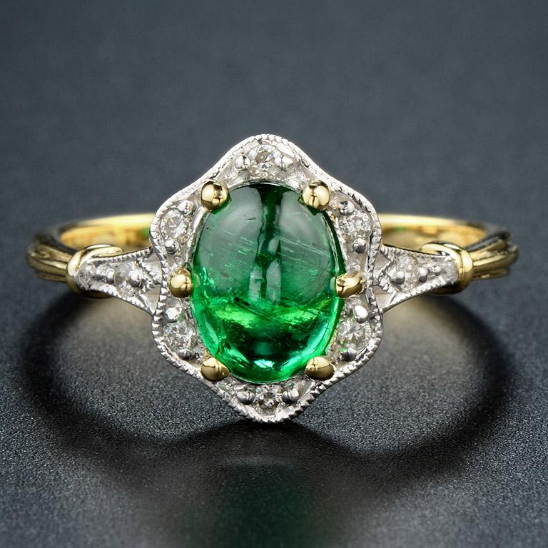 This vintage style ring was made in 18K Gold.   

The ring consists of... 
Natural Emerald 1.65 ct.
Diamond H color SI clarity 0.09 ct.   

The ring was made in size US#7