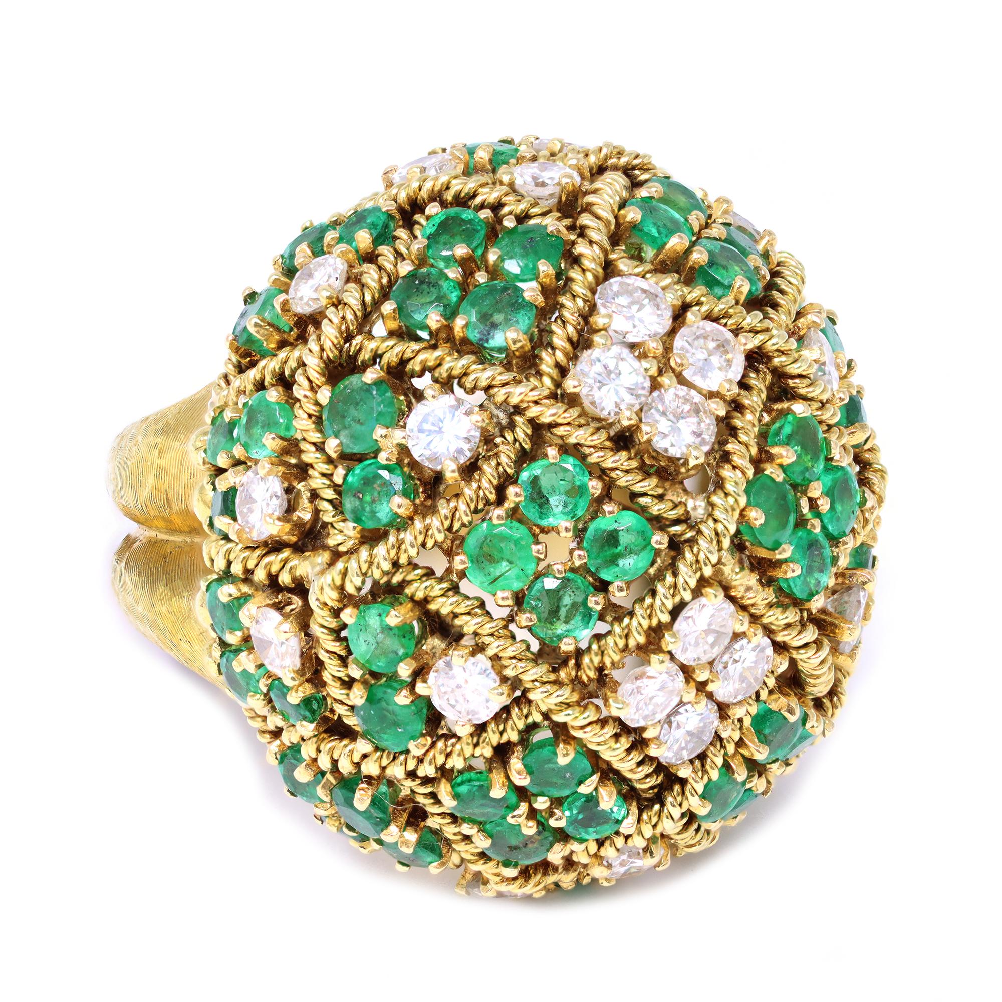 A fantastic Dome design ring circa 1960 featuring a crisscross emerald and diamond design. The ring is set in 18 Karat yellow gold. 
The estimated weight of the diamonds is 1.80 carats GH color VS clarity. The estimated weight of the emeralds is