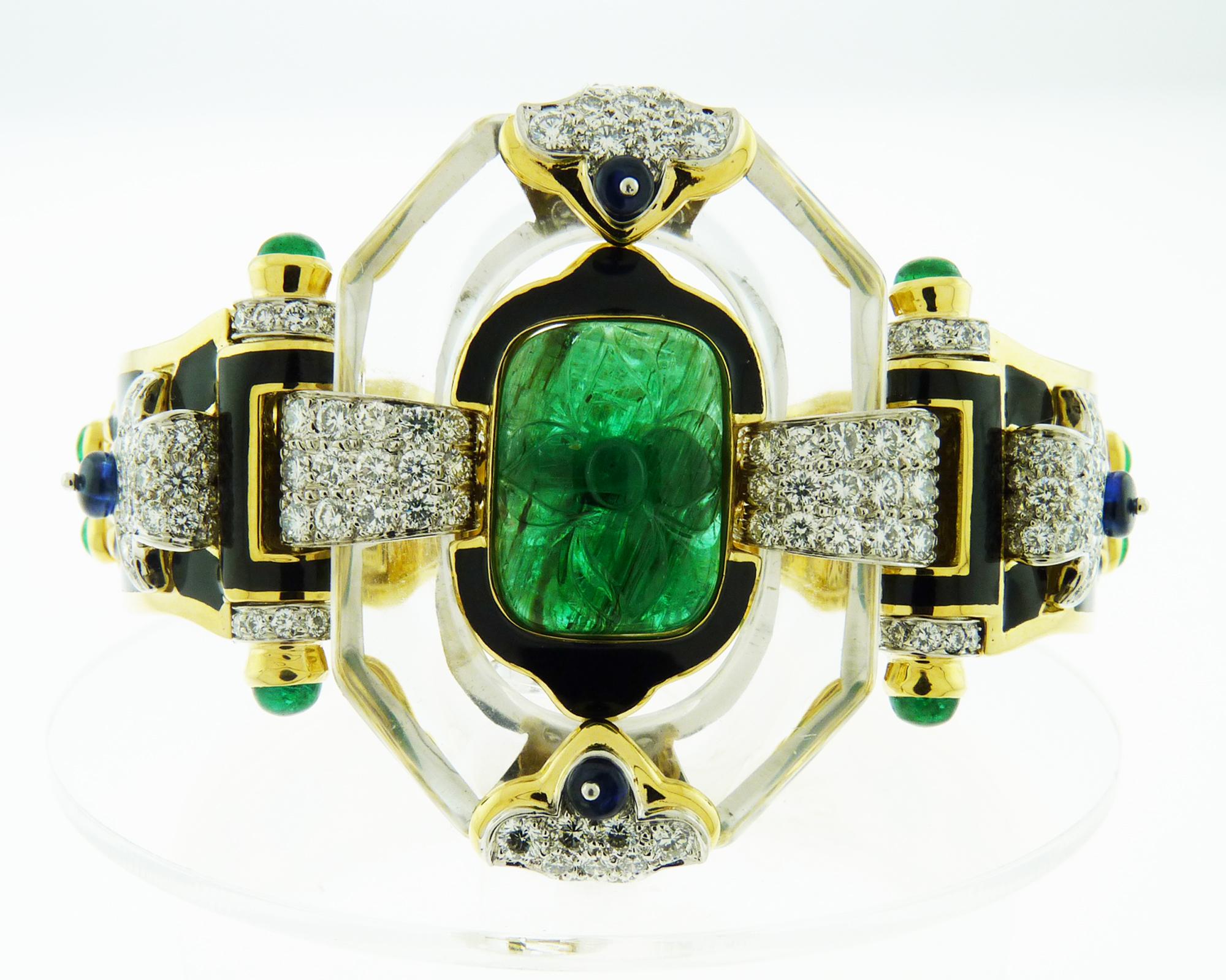 A spectacular Cross River bracelet by David Webb.
Depicting approximately 20.62 carats of carved, cabochon and pear-shaped emeralds, carved rock crystal, 3.18 carats of sapphire beads, 3.44 carats of brilliant-cut diamonds.
It is made with black