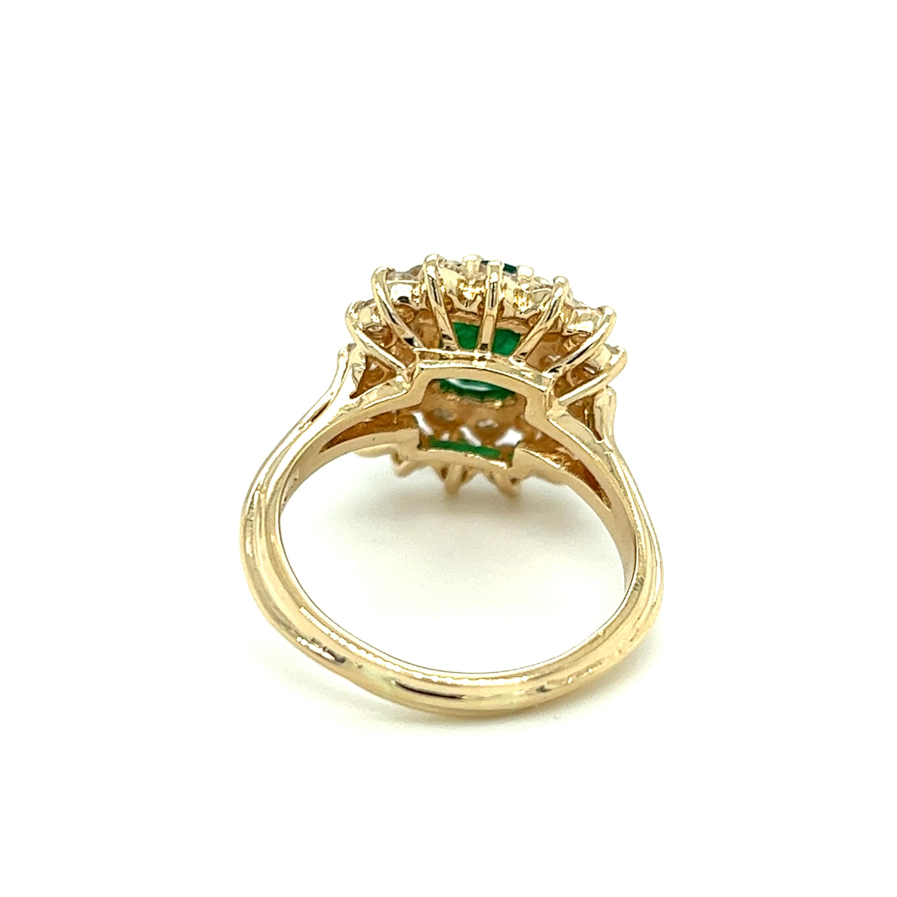 One 14 karat yellow gold cushion shaped cluster ring set with one (1) 1.89 carat oval natural emerald and twenty-eight (28) round brilliant cut diamonds, approximately 1.54 carat total weight with matching H/I color and SI1 clarity. The ring is a