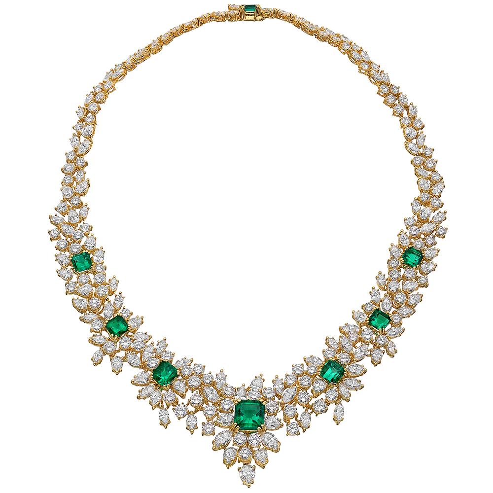 Vintage emerald and diamond demi parure, comprised of a necklace with matching earrings. The necklace designed with a front section composed of seven graduating step-cut emeralds surrounded by pear-shaped, marquise-shaped and round-cut diamonds,