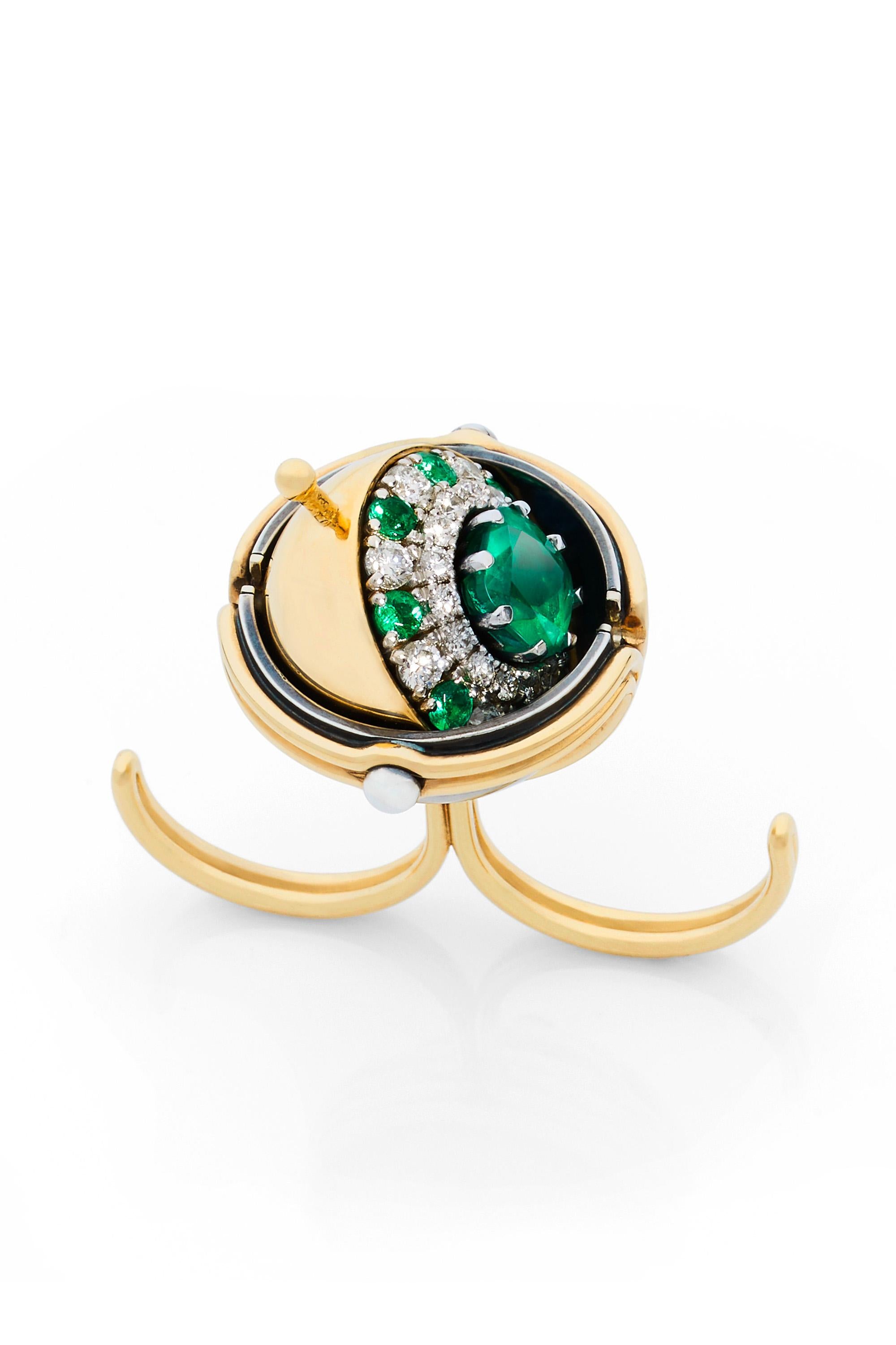 Gold and distressed silver ring. Rotating sphere set with star diamond, revealing an emerald surrounded by emeralds and diamonds.

Details:
Central Emerald : 1.94 cts 
8 Emeralds : 0.55 cts   
25 Diamonds : 1.16 cts
18k Gold : 27g 
Distressed Silver