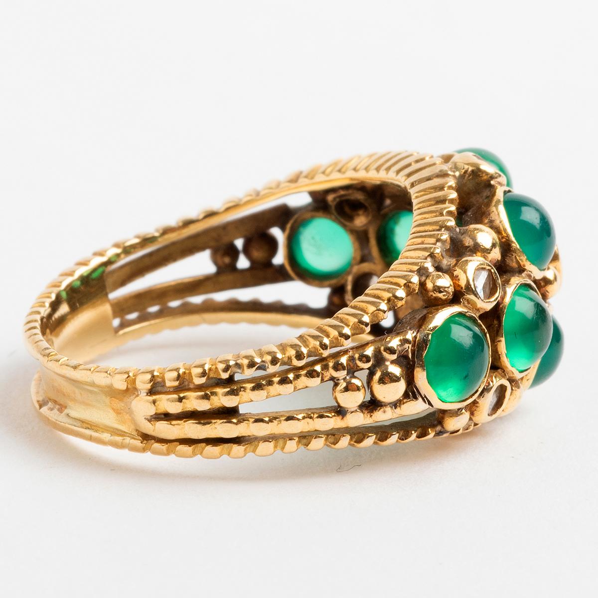 A vintage emerald and diamond dress ring, set in 18k yellow gold with a decorative bead effect shank, our prominent continental ring is hallmarked for import and dates from circa 1960s. The stones cover 2.3cm x 1cm and stand 7mm high. This ring is a