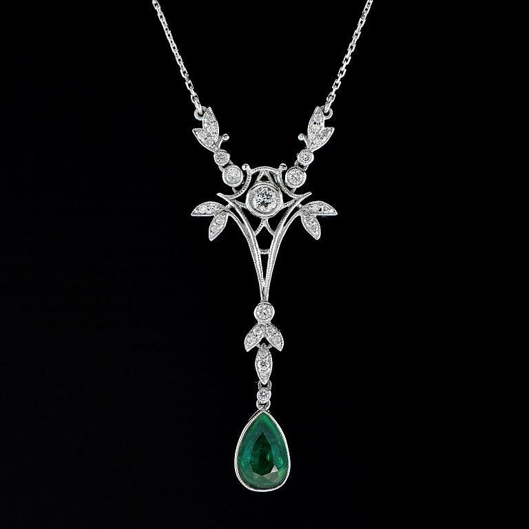 This floral-designed necklace spectacularly displays a fine pear-shaped natural Colombia Emerald studded excellently in a classic 18K white gold setting on the charismatic floral pattern with tiny glistening round brilliant cut diamond held