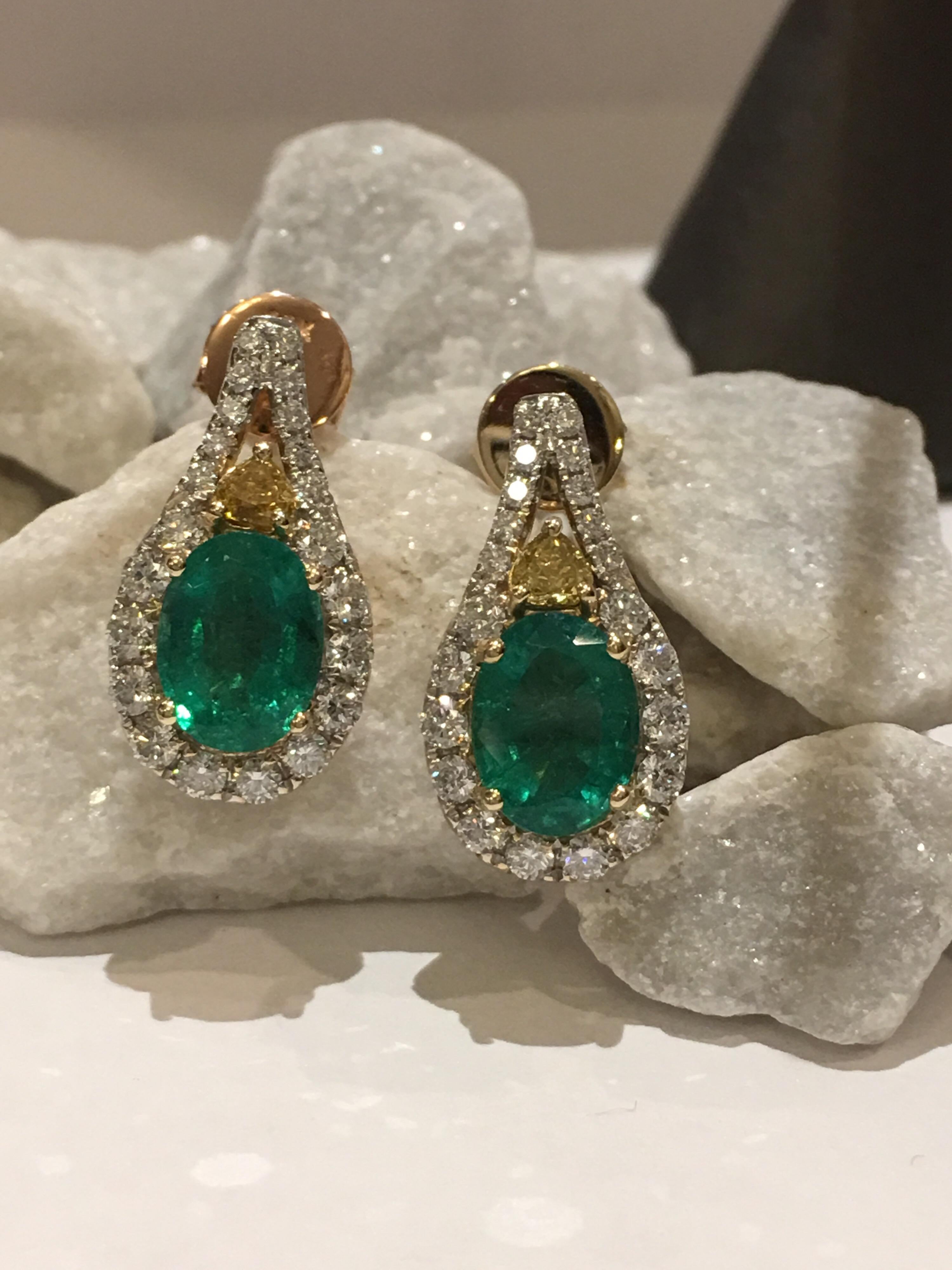 Natural Emerald with White and  Yellow Diamonds set in 14K Yellow Gold .
Oval Emerald Total weight is 2.10 Carat. White Diamonds weigh 0.76 Carat and Yellow Diamonds weigh 0.19 Carat.
The earring is one of a kind ,Handcrafted push back post