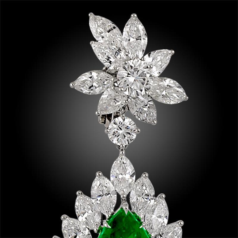 A magnificent pair of contemporary emerald and diamond earrings; each set with a fine, vivid green pear emerald within a spray of marquise diamonds, suspended from a surmount of marquise and brilliant-cut diamonds.

The earrings are mounted in