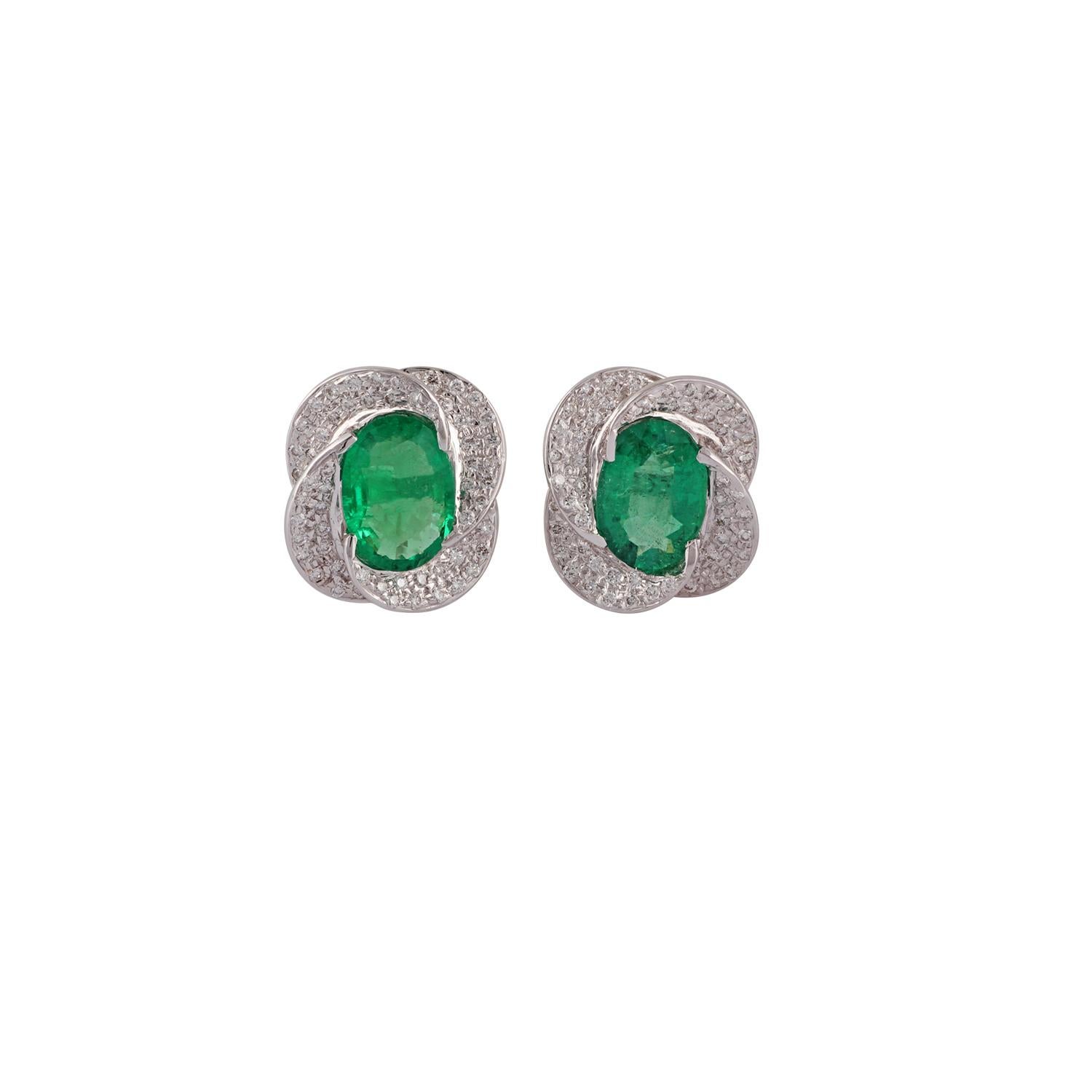 These are an elegant emerald & diamond earrings pair studded in 18k white gold features 2 pieces of oval shaped emeralds weight 5.40 carat with round shaped brilliant cut diamonds weight 1.68 carat, these earrings entirely studded in 18k white gold
