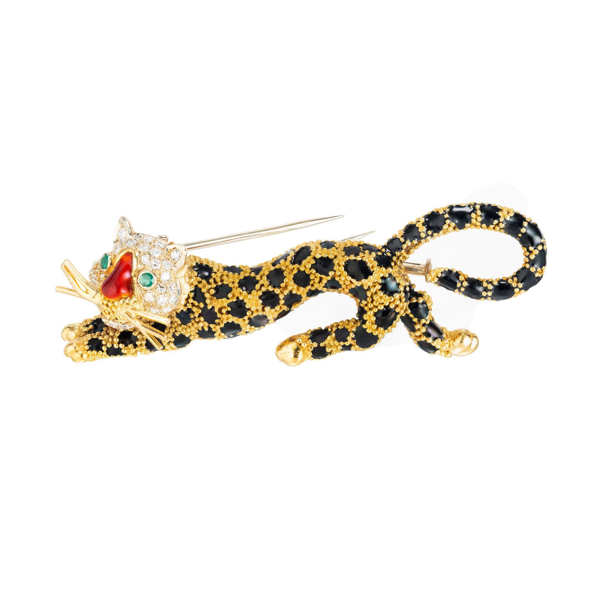 Diamond and emerald Leopard brooch. Black and red enamel with emerald eyes and a pave diamond face and 18k yellow gold whiskers. Double stem pin catch. 

32 round diamonds approx. total weight .25cts
2 round emeralds 2mm each
18k yellow