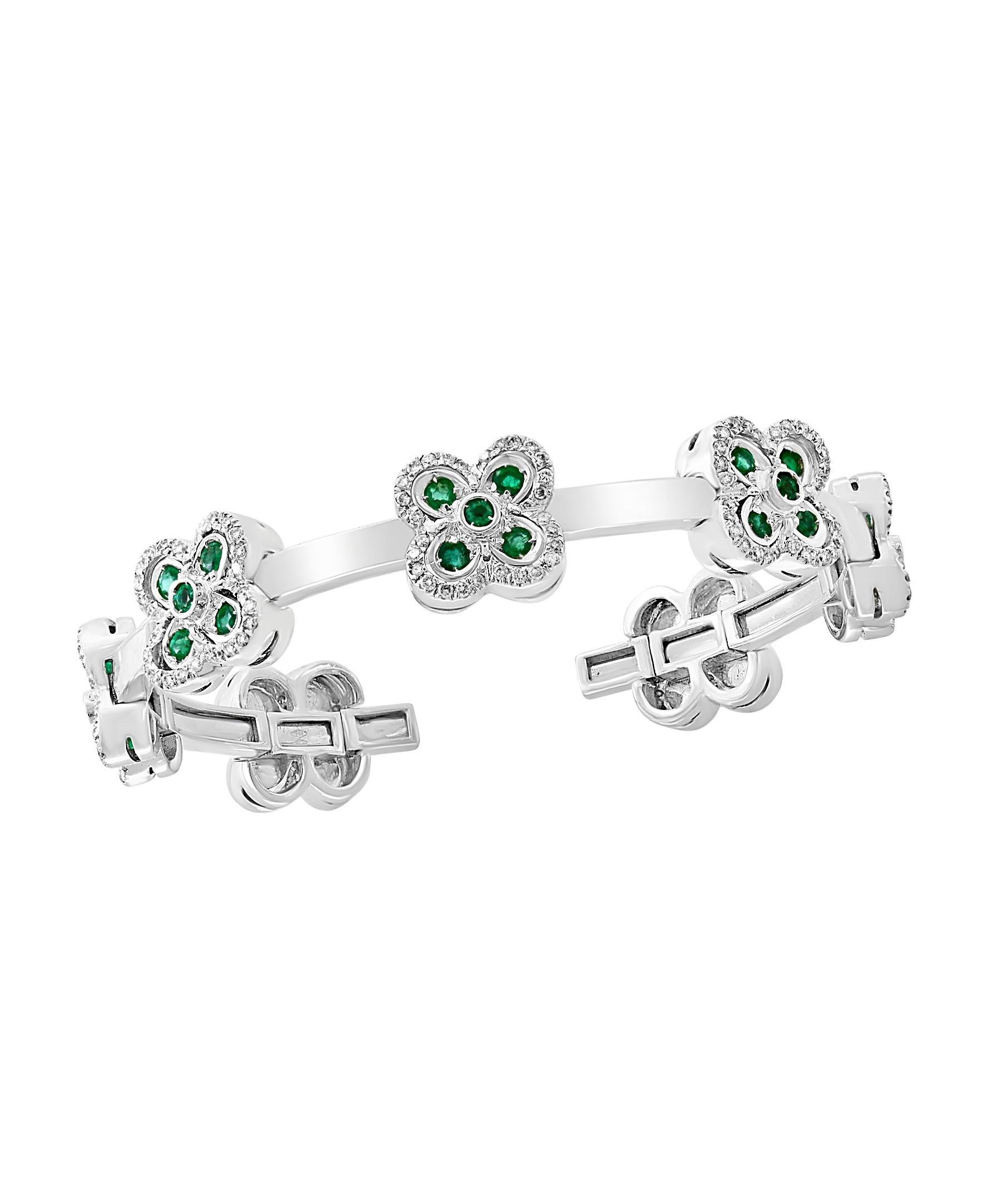 Emerald & Diamond & Gold 37 Grams  Cuff Bangle /Bracelet In 18 Karat White Gold
It features a bangle style  Bracelet crafted from an 18 Karat  White  gold and embedded with  7 Flowers out of which 5 flowers  have Emerald diamonds  petals surrounded