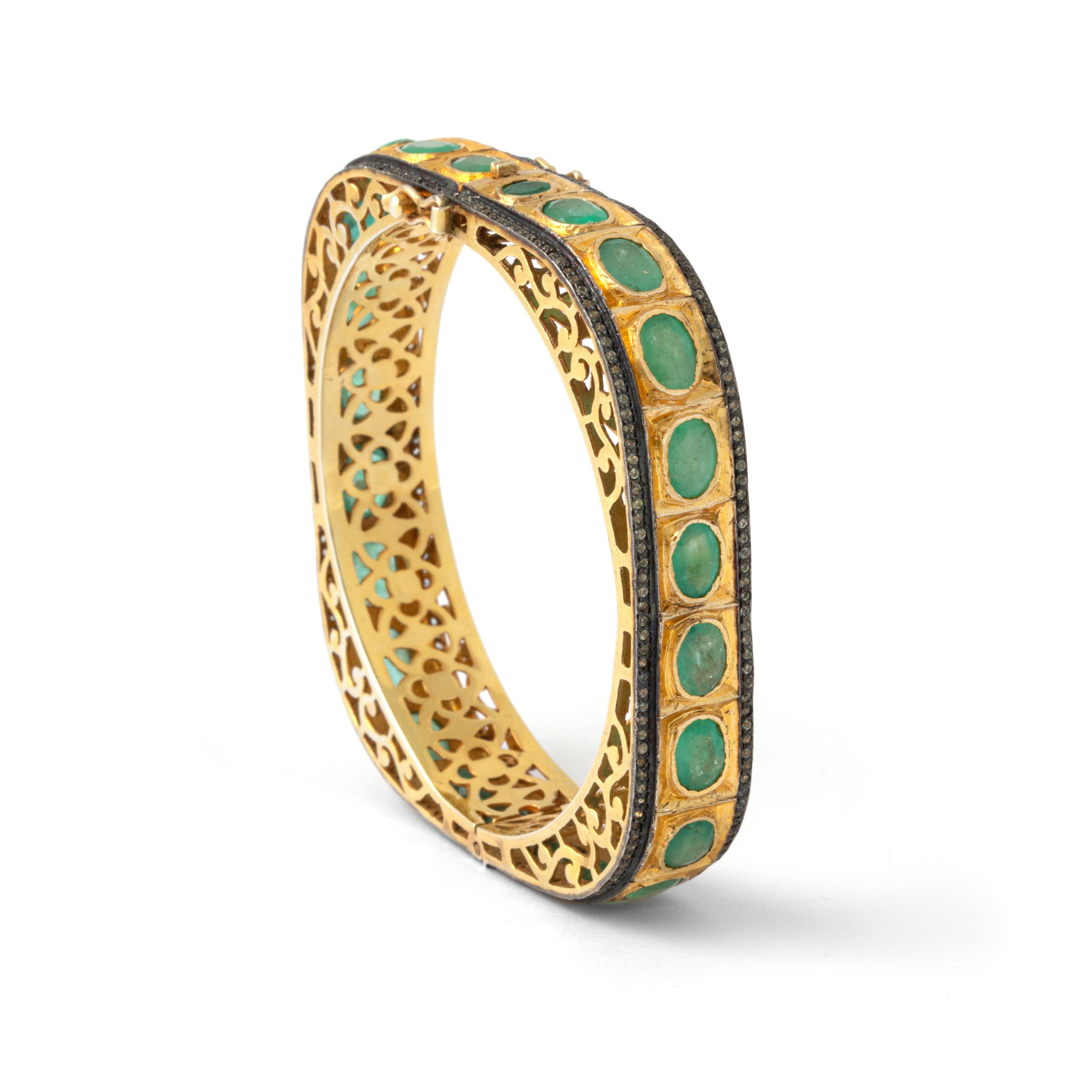 Emerald and Diamond Gold Bangle Bracelet.

Behold the allure of this captivating Emerald and Diamond Gold Bangle Bracelet, a masterpiece of Indian craftsmanship.

This exquisite bangle seamlessly combines the richness of gold with the vibrancy of