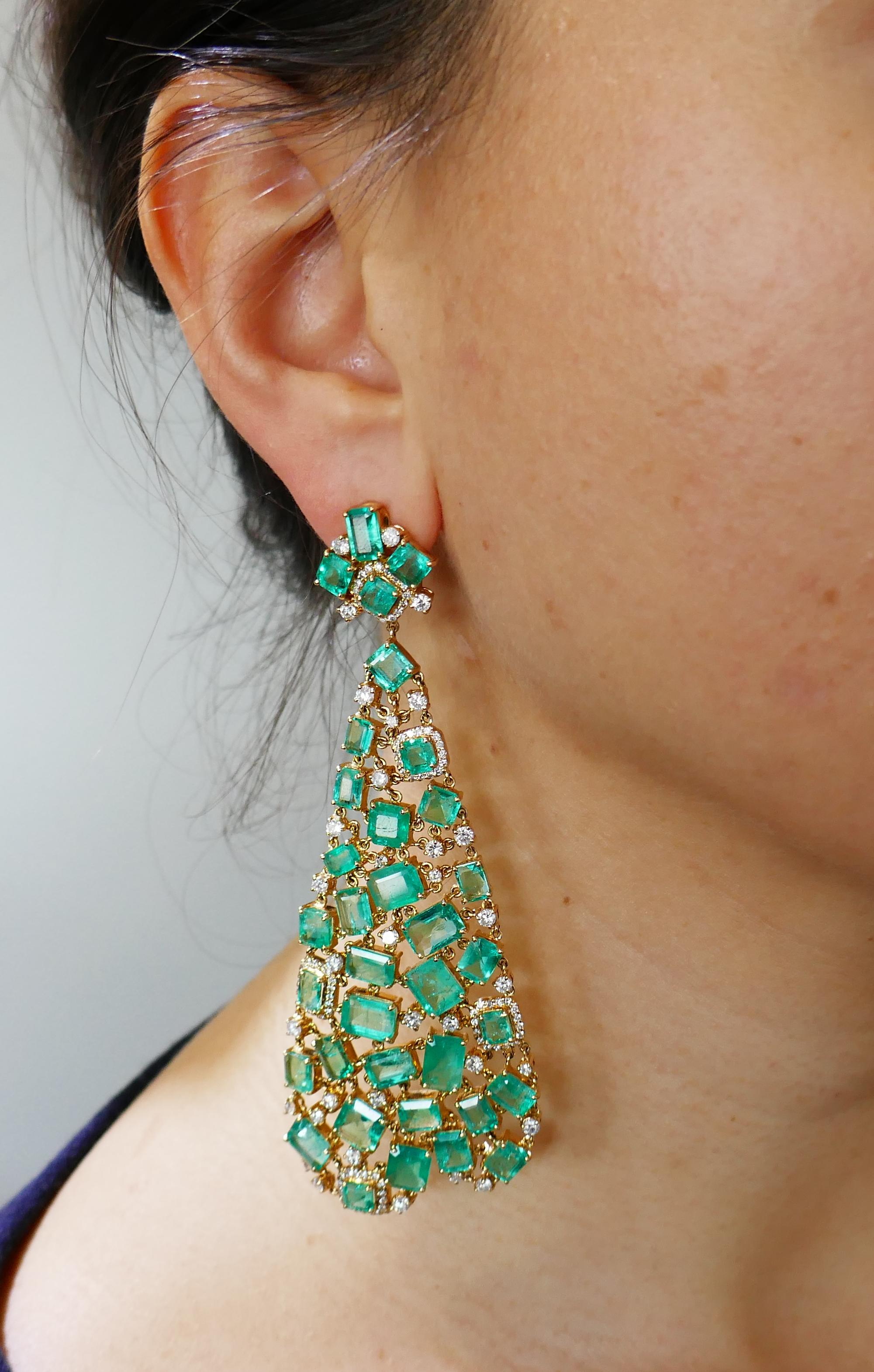 Dramatic dangle earrings.
The earrings are made of 18 karat (tested) yellow gold and set with emeralds and round brilliant cut diamonds. Beautiful color combination of vivid green emeralds and sunshine of yellow gold with a subtle sparkle of