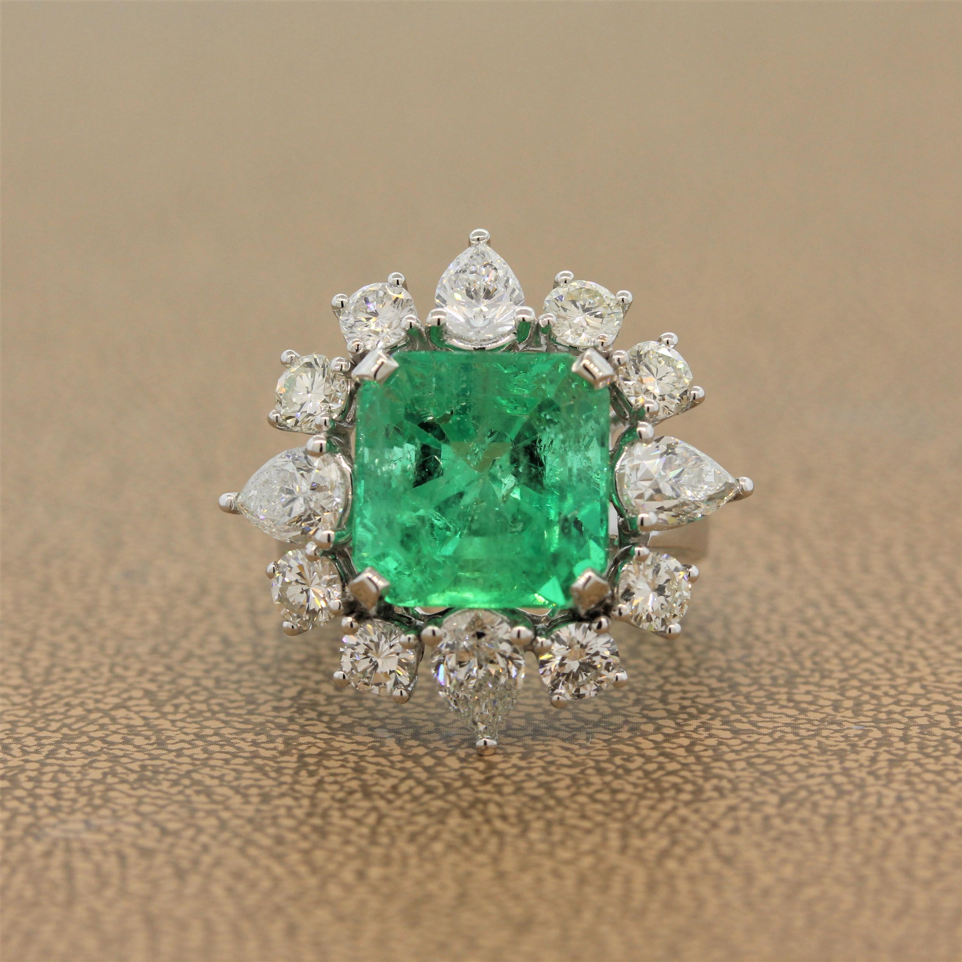 A magnificent emerald ring featuring a 8.14 carat emerald cut emerald with a lush vivid color. The gemstone is haloed by large pear and round cut diamonds totaling 3.45 carats. They are set in a custom made 18K white gold mounting to hold the